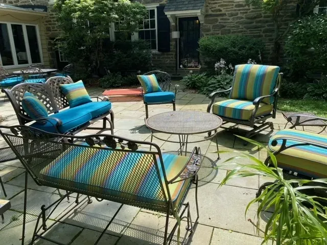 A patio with a couch , chairs , and a table