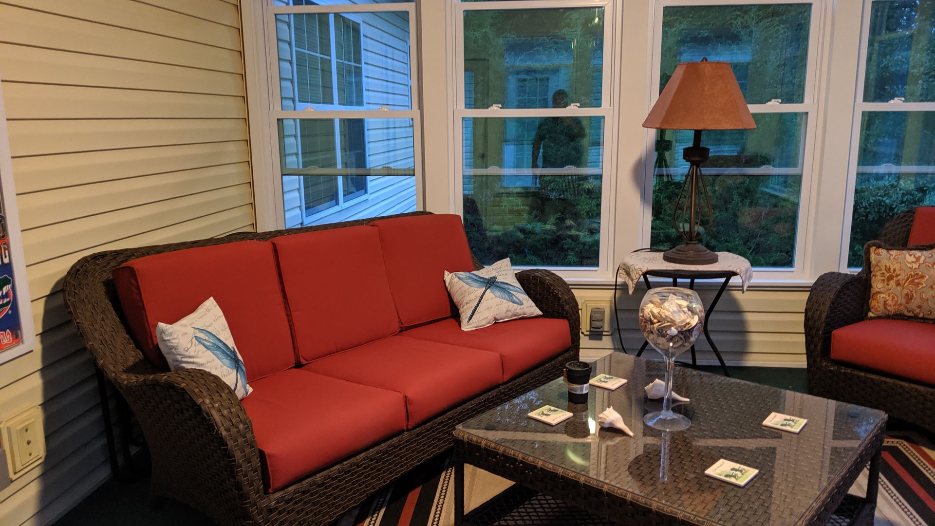 A living room with a couch a table and a lamp