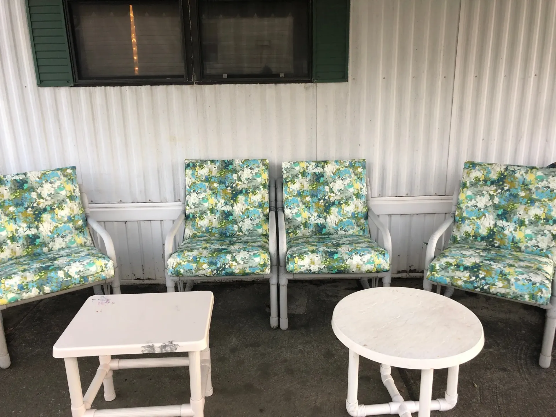 A patio set with chairs , a table , and a bench.
