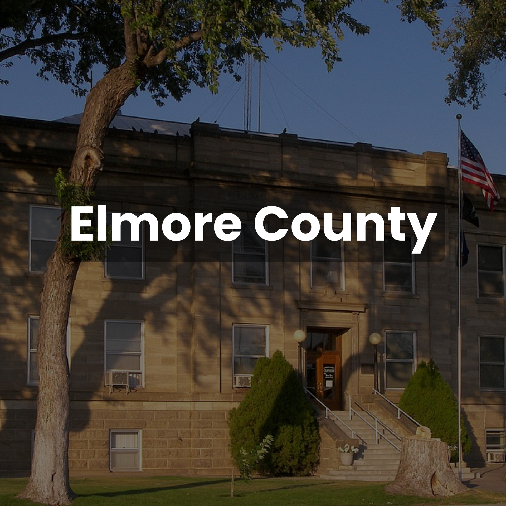 Elmore County Courthouse with American flag flying in front.