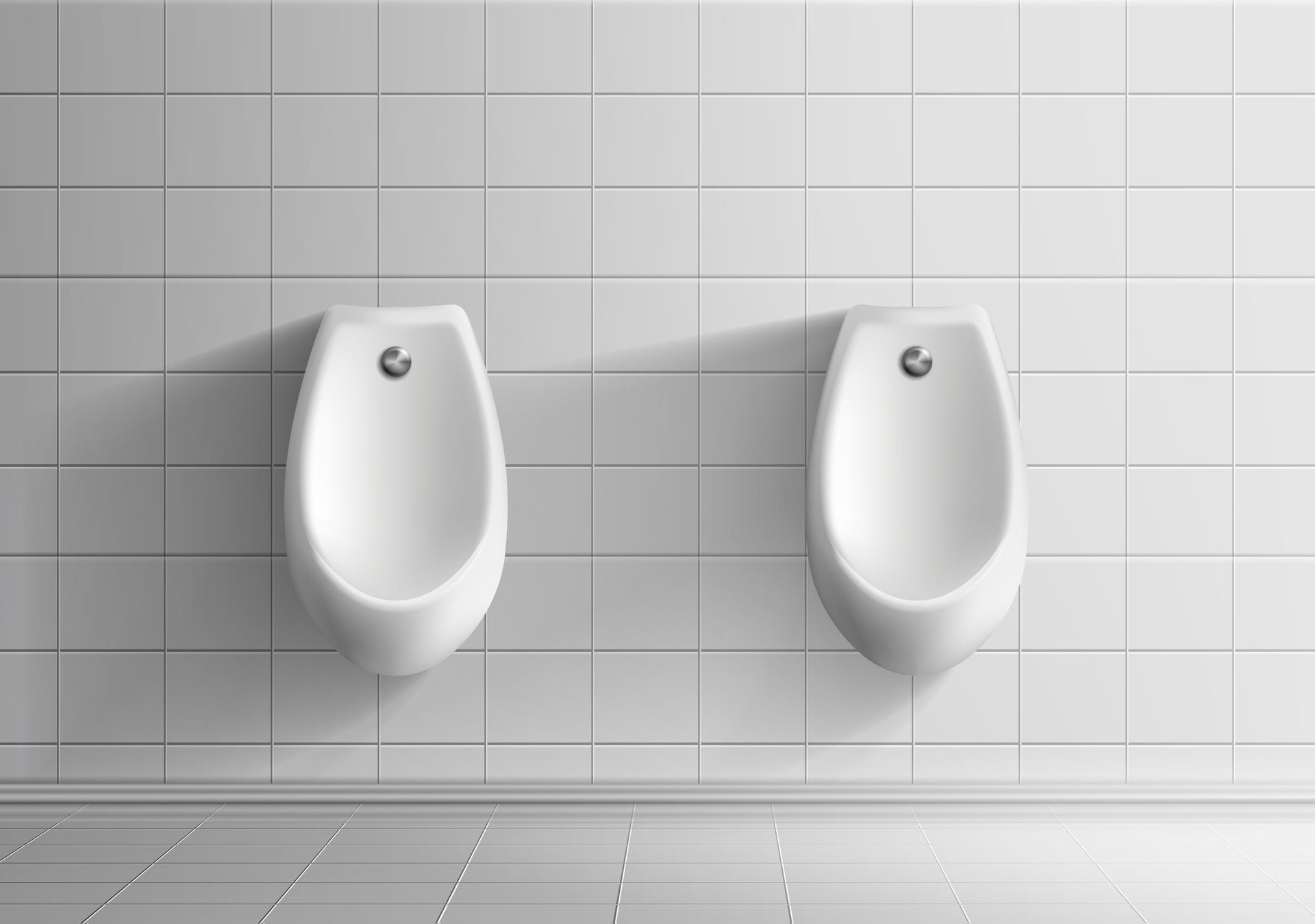 Two white urinals mounted on a tiled white wall in a restroom.
