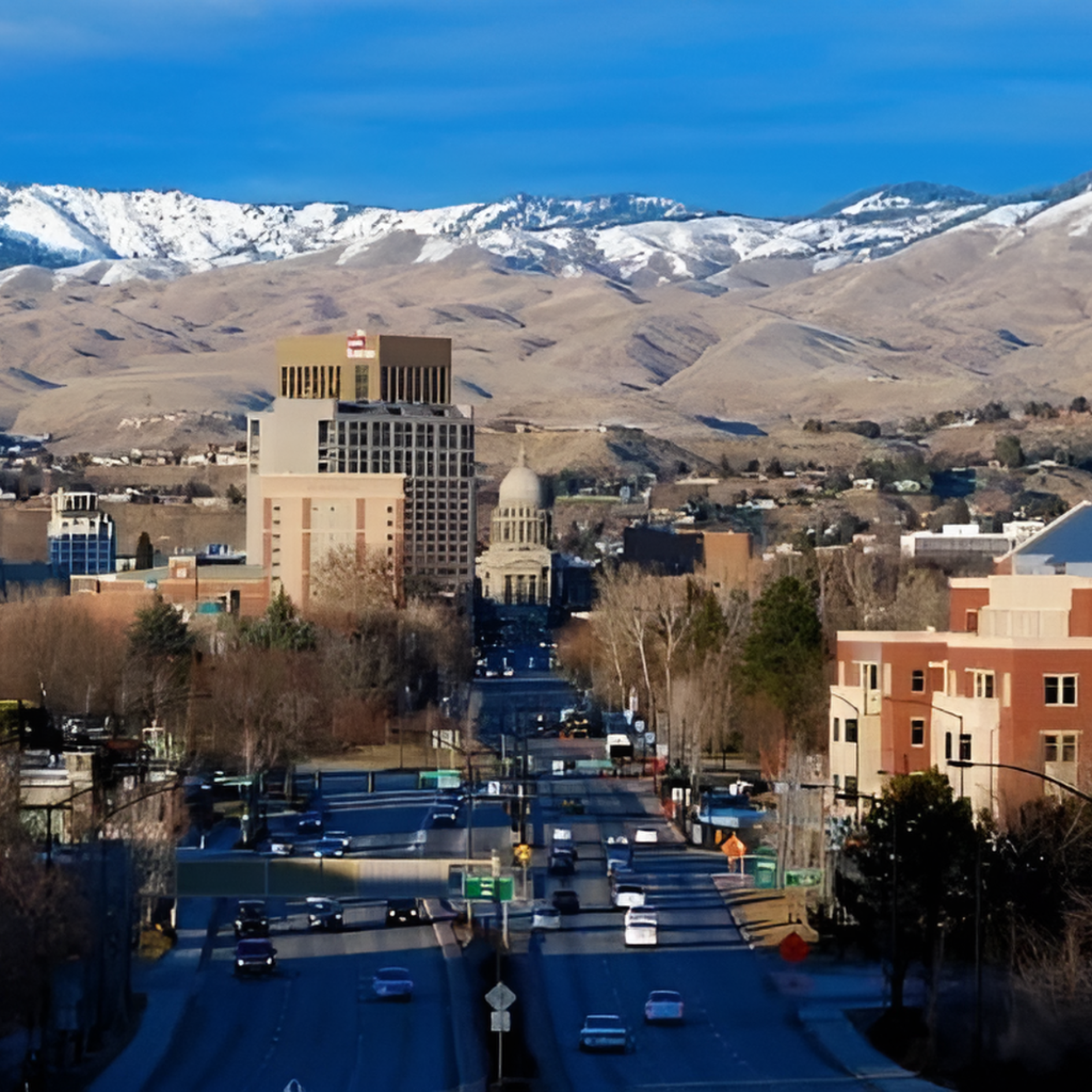 Eagle Boise, Idaho skyline, road leading to state capitol building, mountains in background.