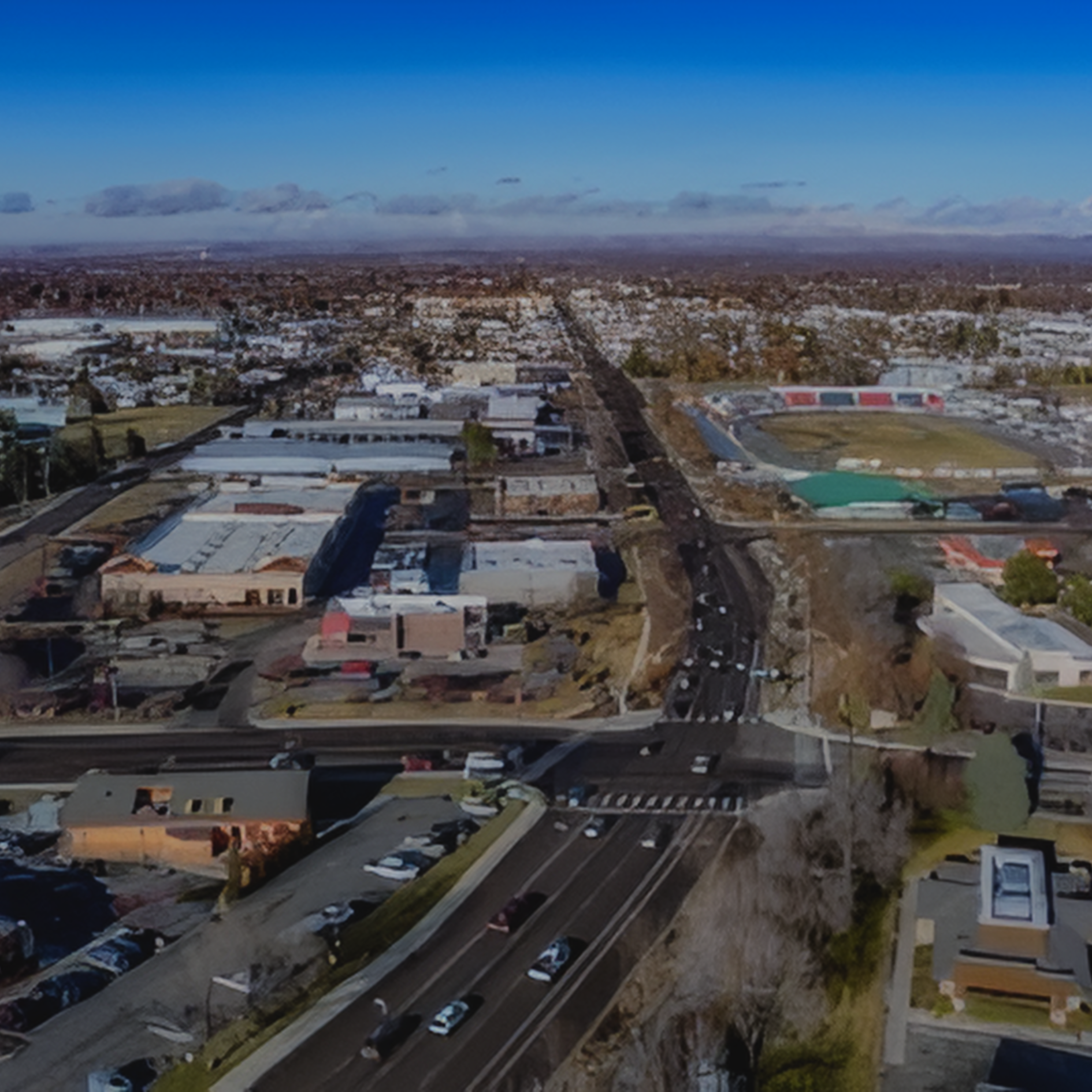 Boise Aerial view of a city street with cars, buildings, and a clear blue sky.