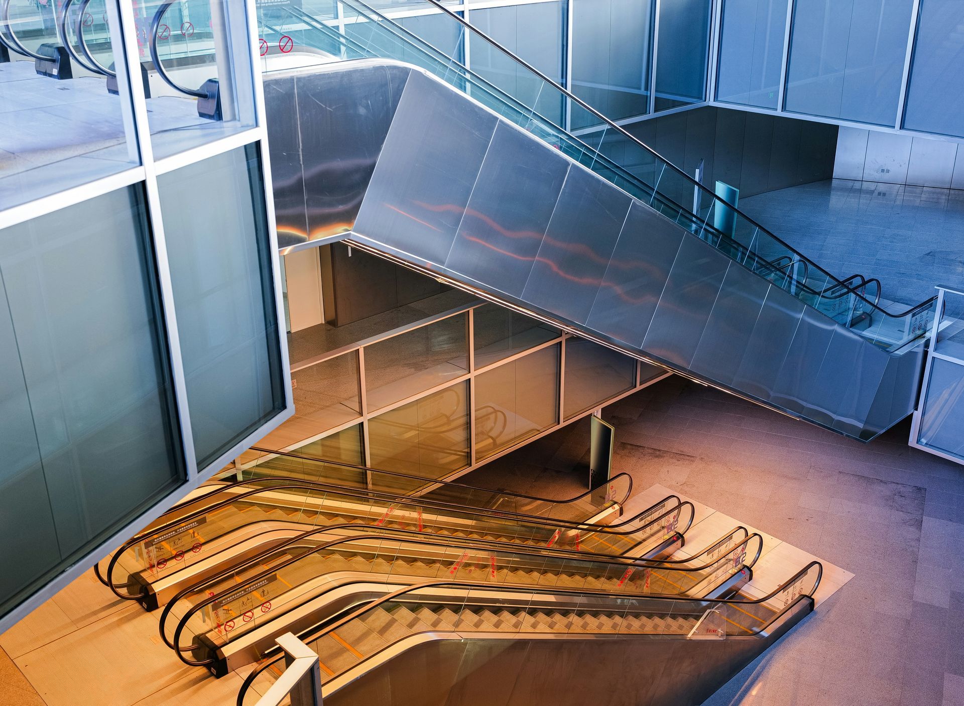 Escalators at different angles within a modern building.