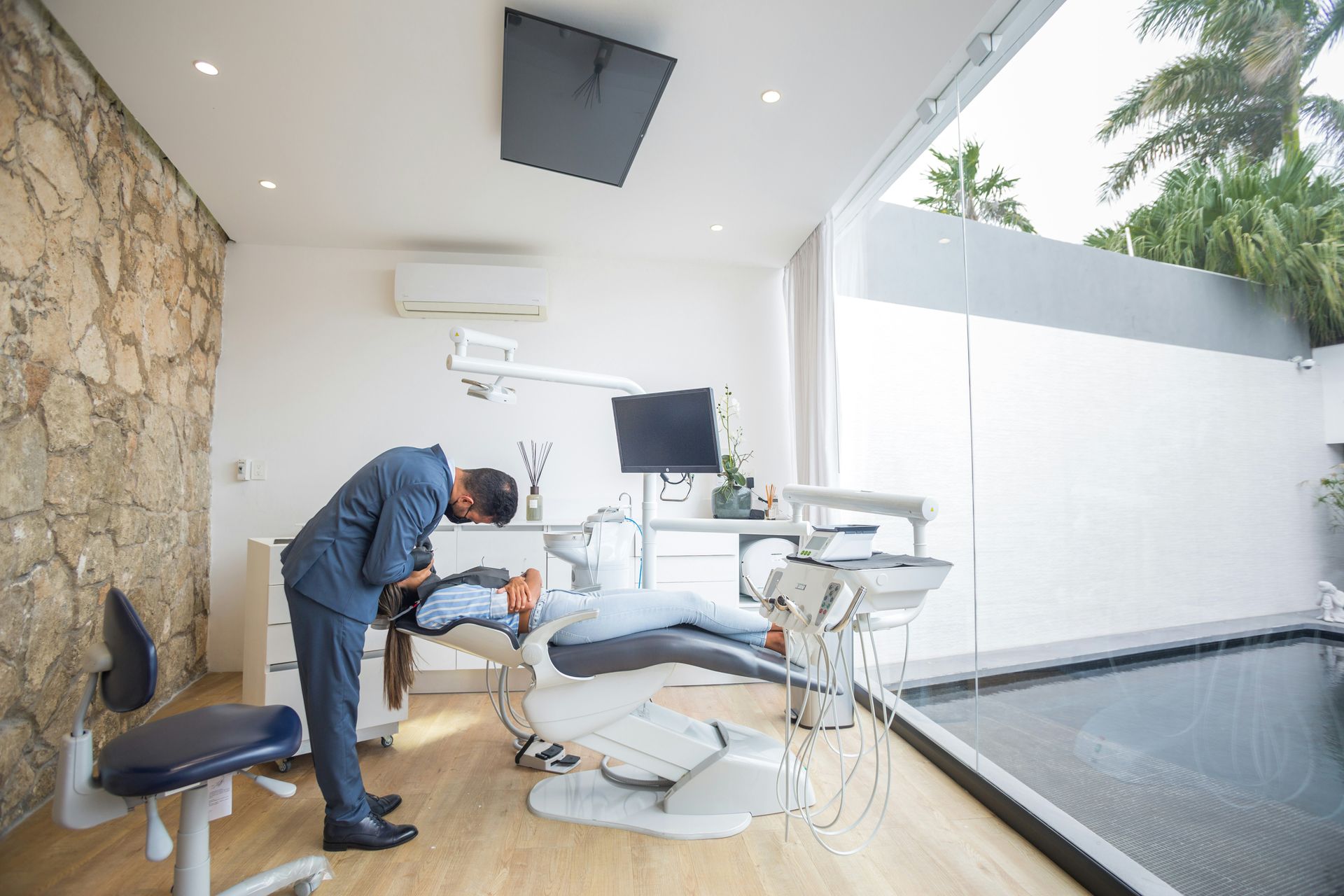 Dentist examining a patient in a modern dental office.