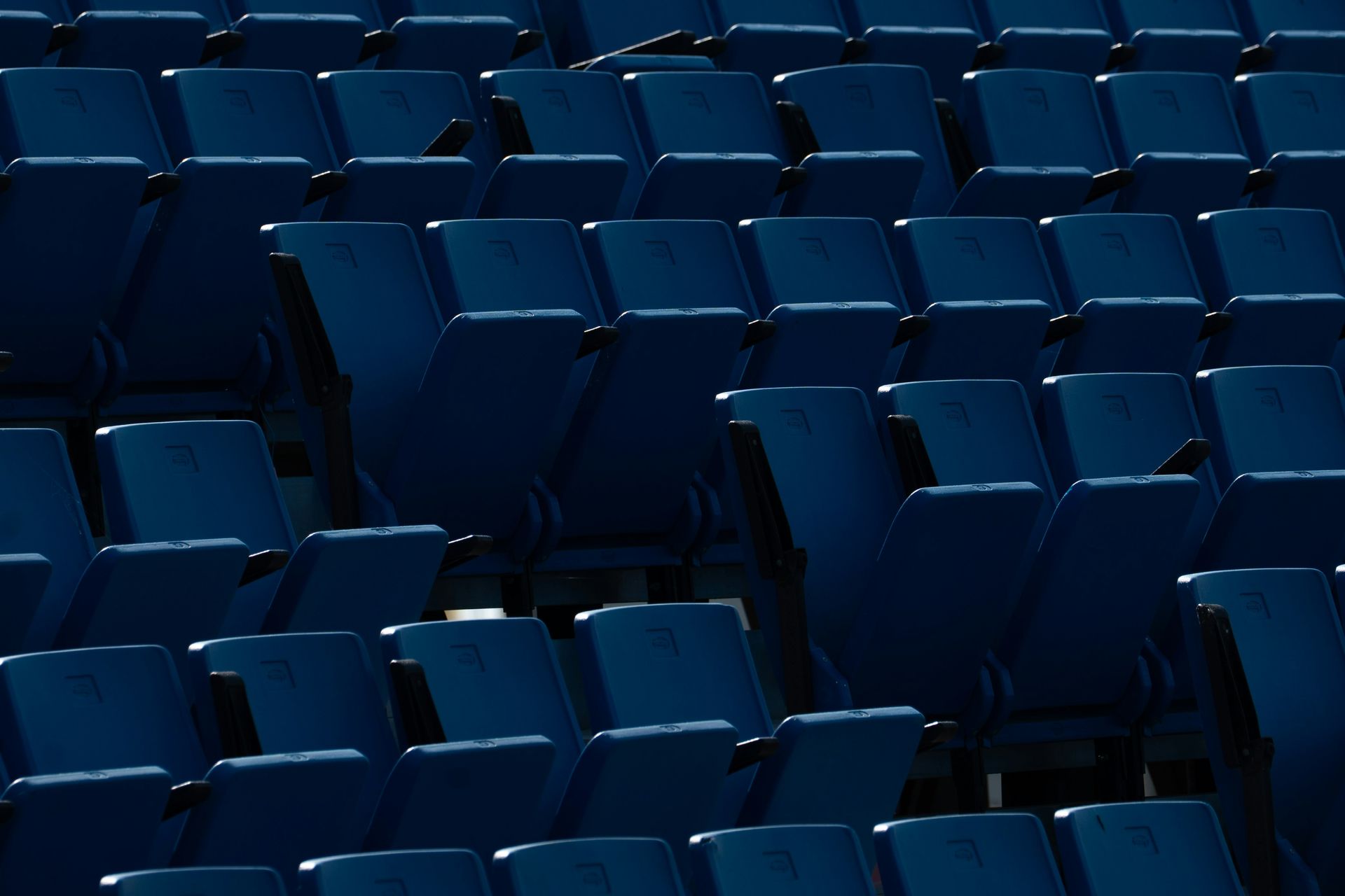 Empty blue stadium seats.