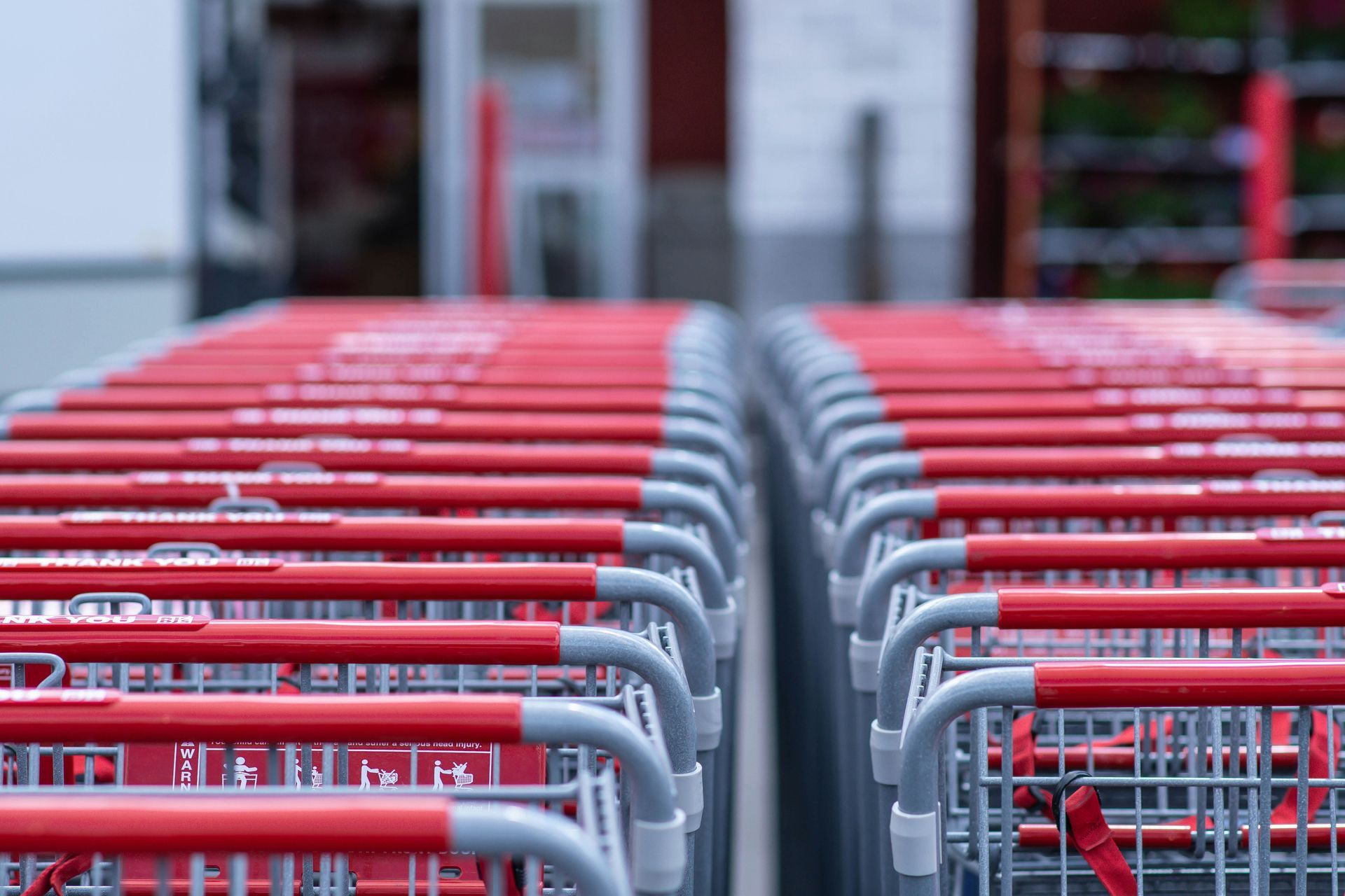 Rows of red shopping carts outside a store.