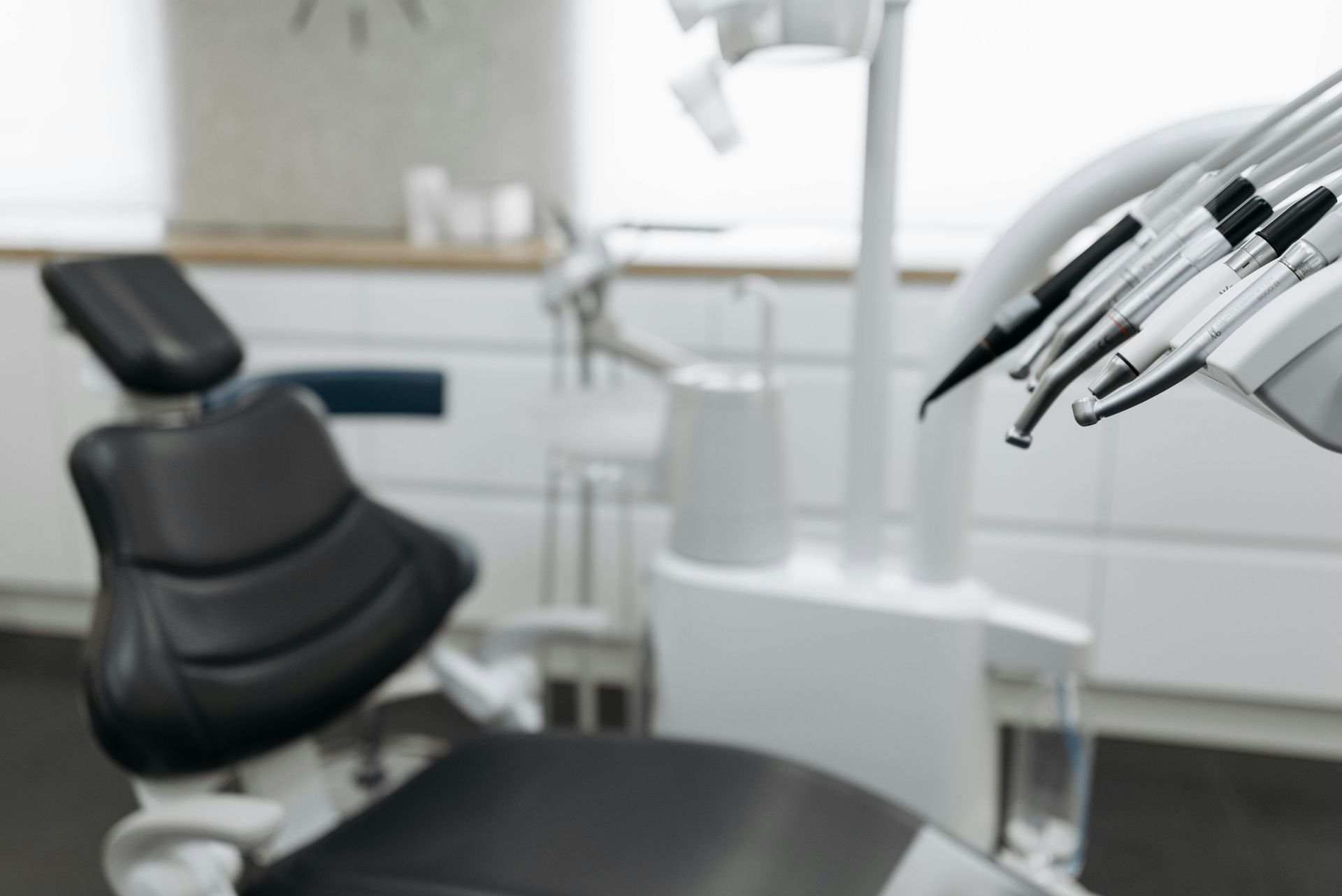 Dental chair and equipment in a clean, modern dentist's office.
