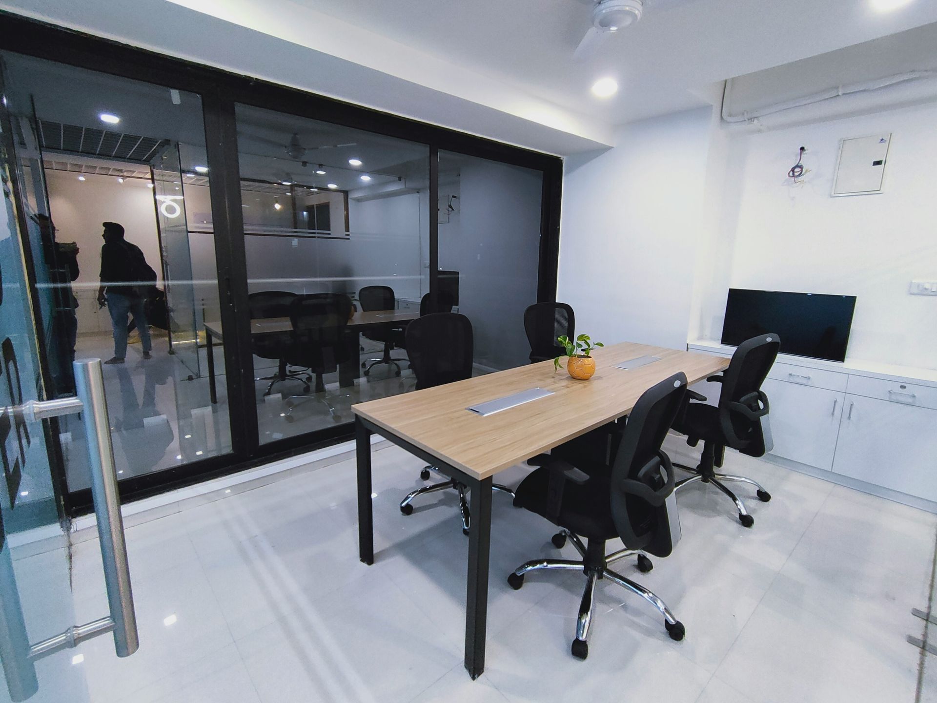 Conference room with table, chairs, glass wall. Interior view of an office.