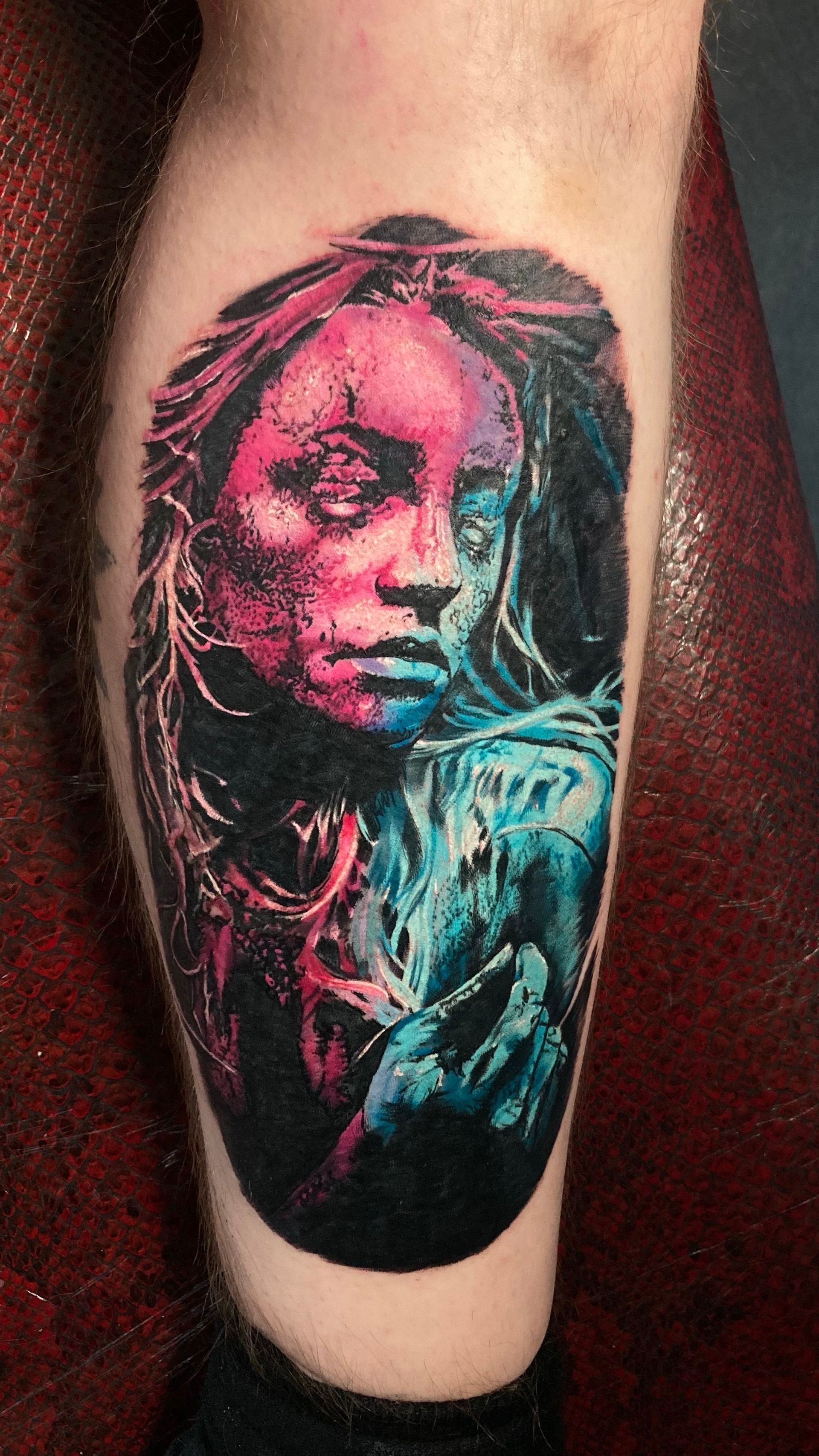 Tattoo of a person with pink and blue hues. They appear to be holding an ice-like object with a dark background.