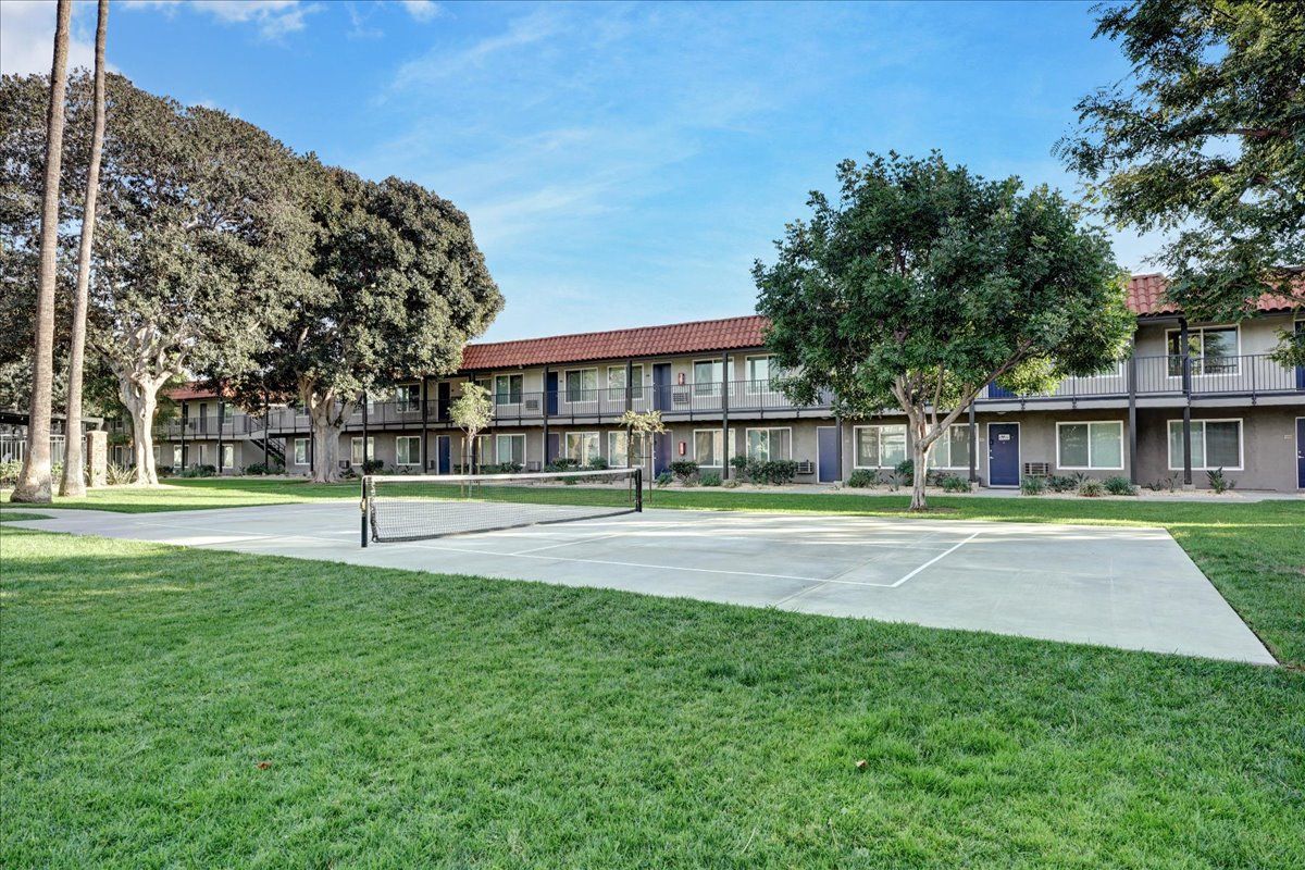 There is a basketball court in front of a building.