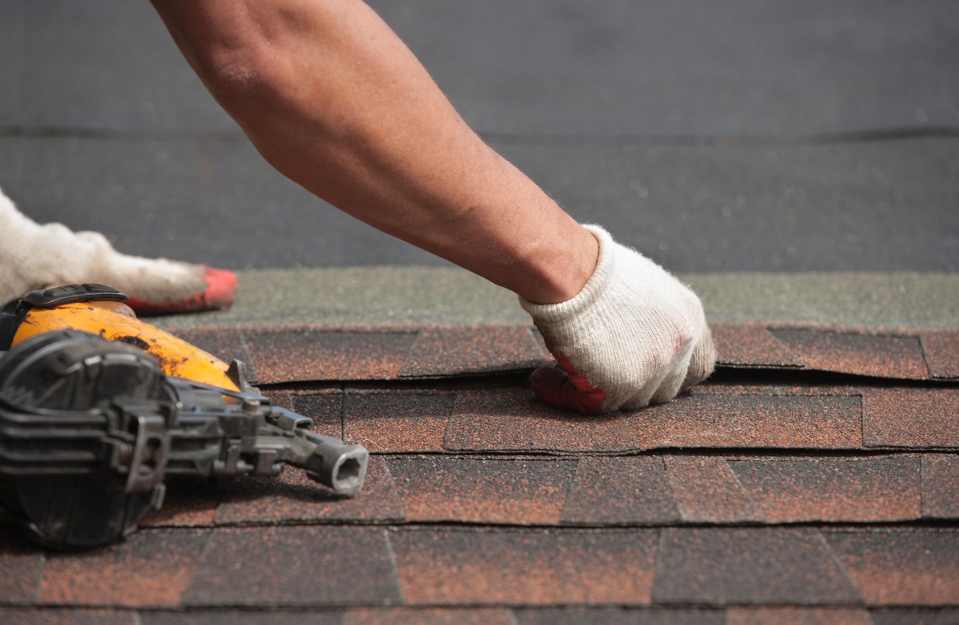 Experienced roofer installing a new roof on a residential home.