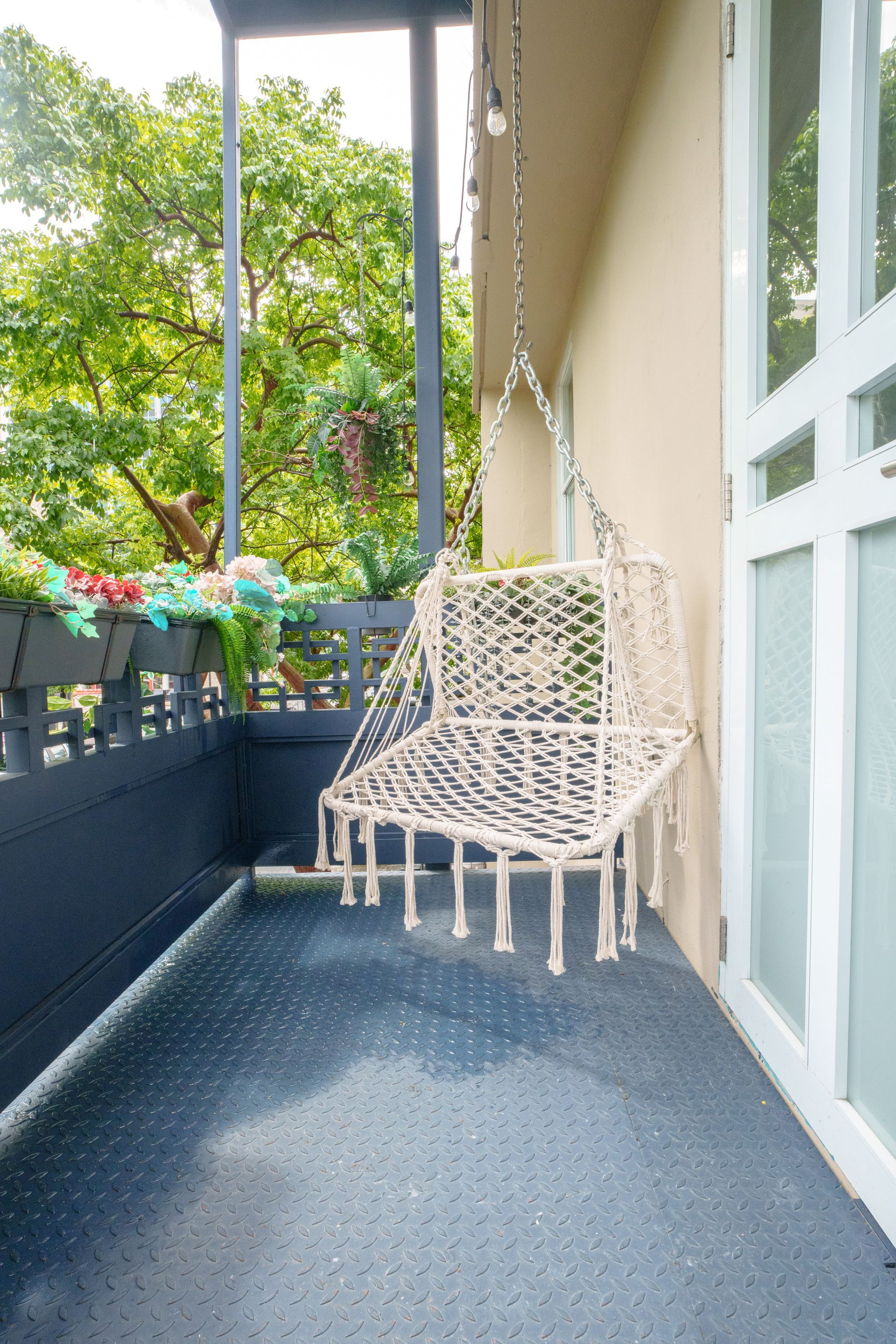 A hanging chair is sitting on a balcony next to a door. Somos Hotel San Juan, Puerto Rico Avenida Ponce de Leon