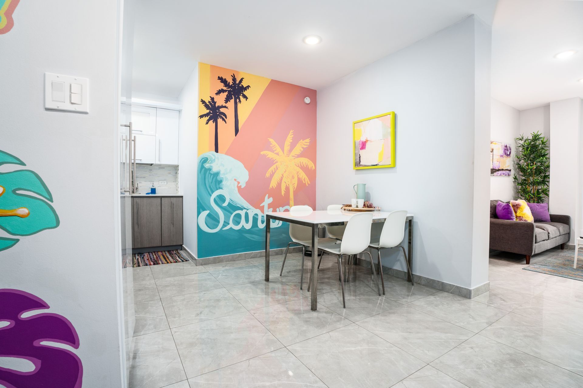 A living room with a dining table and chairs and a painting on the wall. Somos Hotel San Juan, Puerto Rico Avenida Ponce de Leon