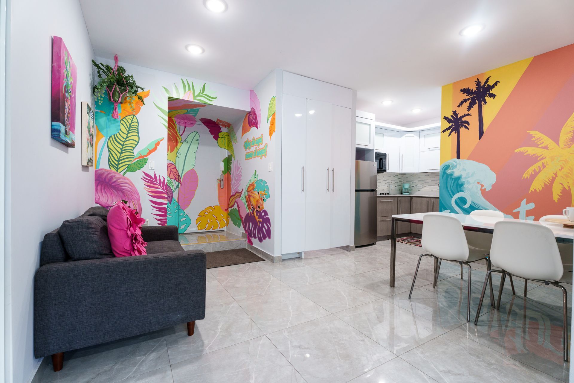 A living room with a couch , table and chairs and a colorful mural on the wall. Somos Hotel San Juan, Puerto Rico Avenida Ponce de Leon