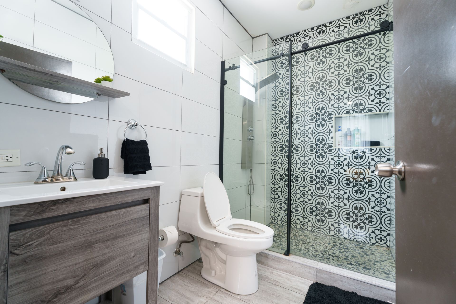 A bathroom with a toilet , sink , mirror and walk in shower. Somos Hotel San Juan, Puerto Rico Avenida Ponce de Leon