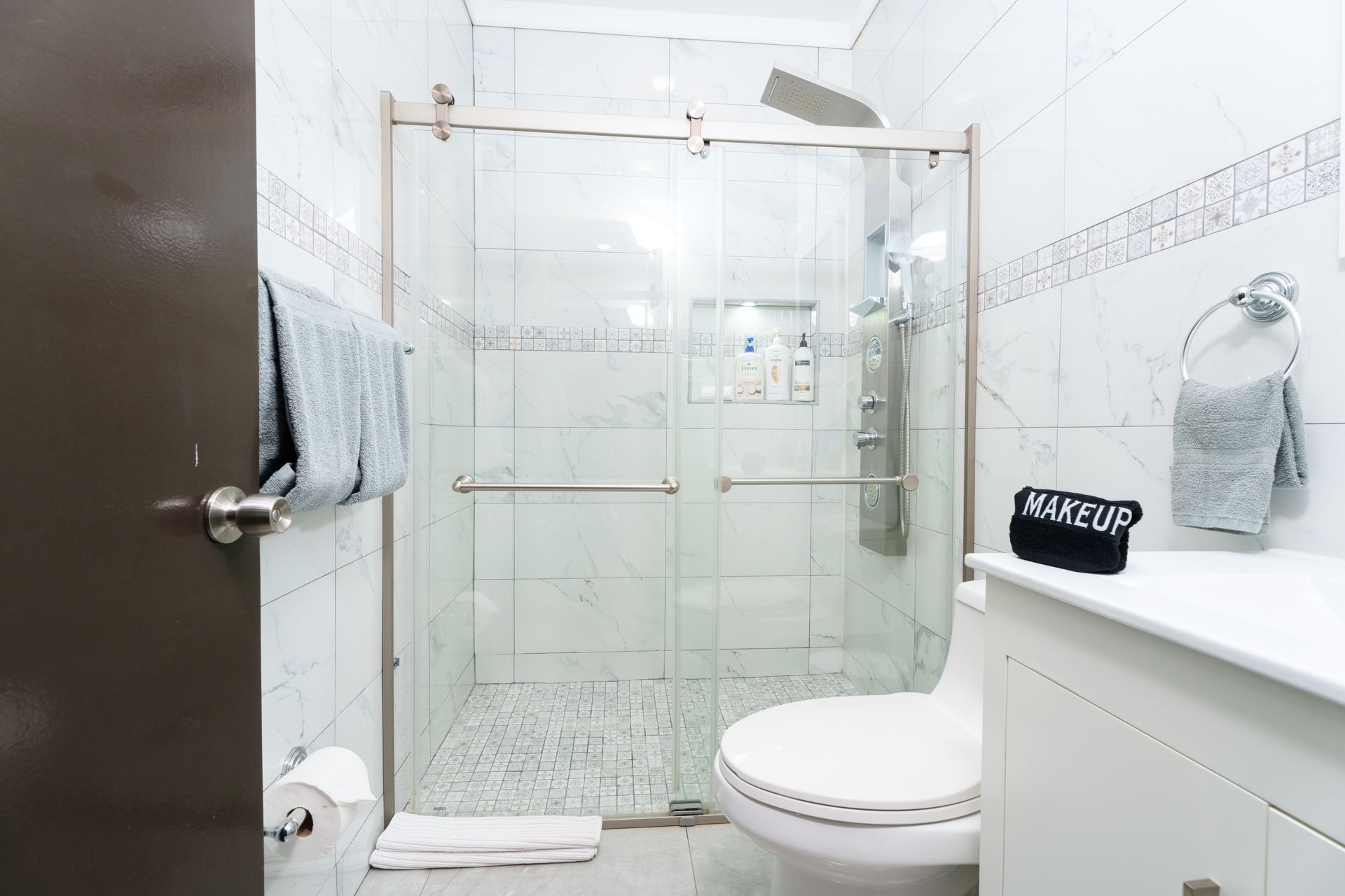 A bathroom with a toilet , sink , shower and glass door. Somos Hotel San Juan, Puerto Rico Avenida Ponce de Leon