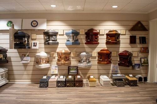 Wall display of colorful handcrafted baskets and woven goods in a well-lit shop or gallery.