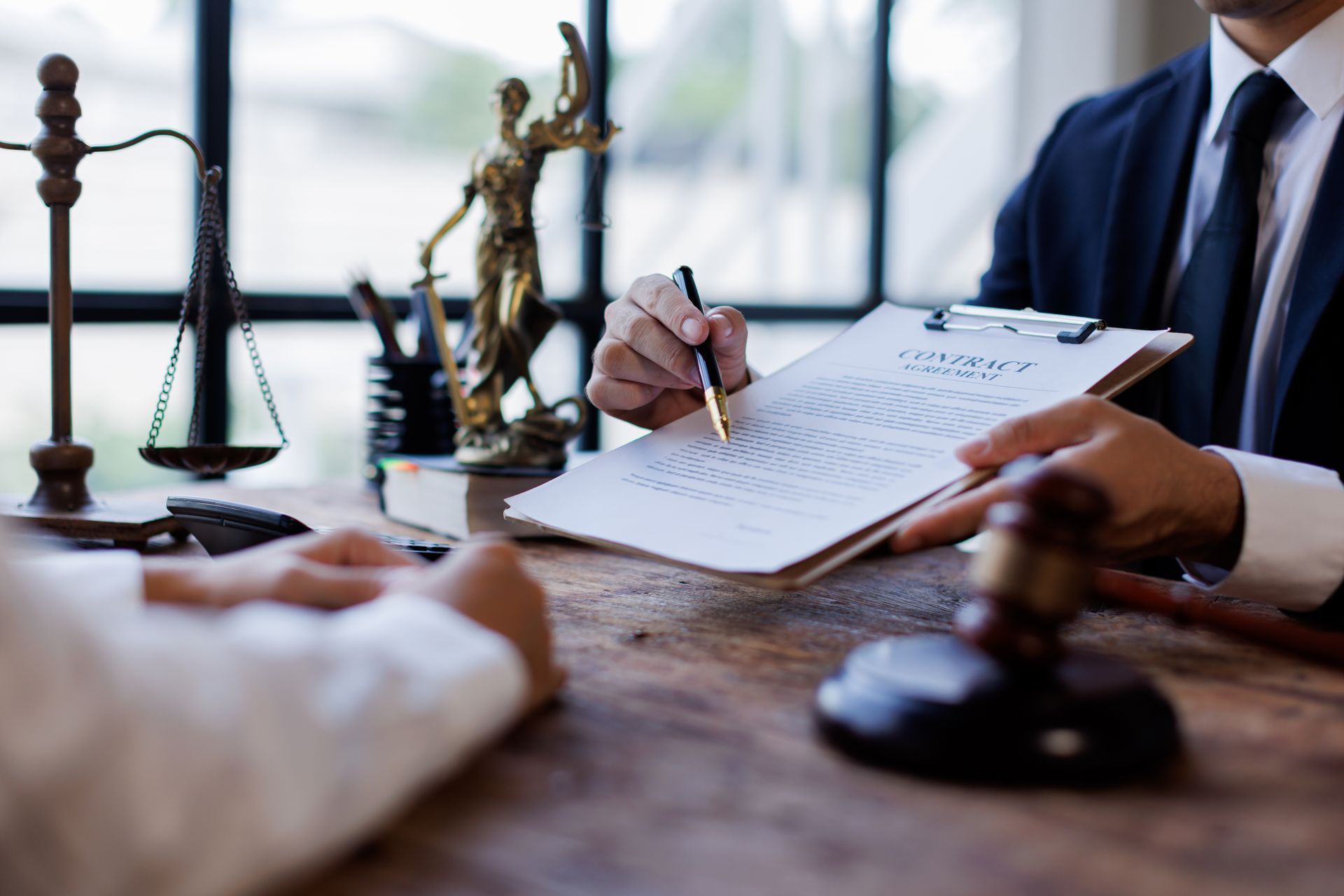 Personal injury attorney reviewing a contract with a client