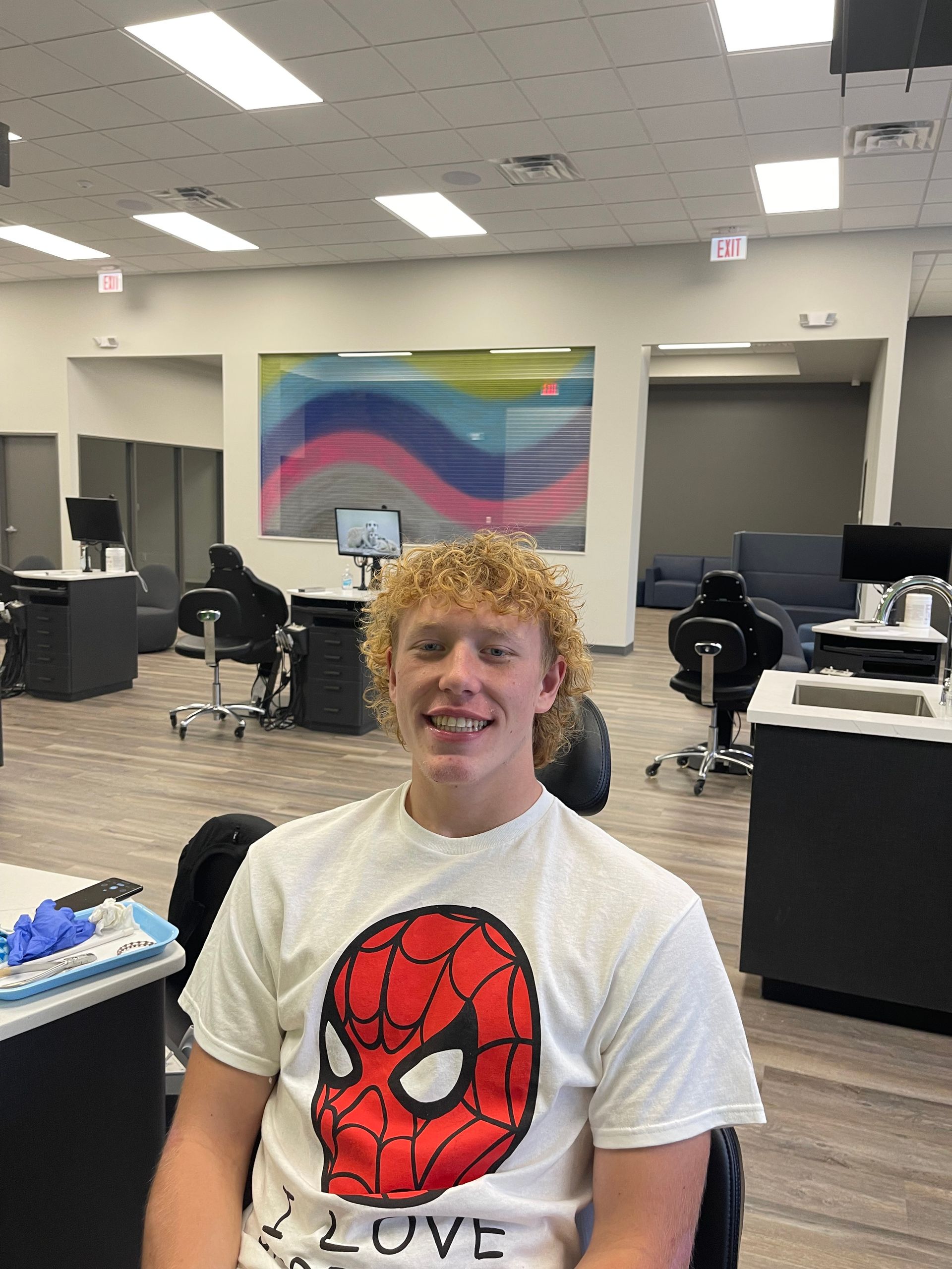 boy smiling after getting braces removed