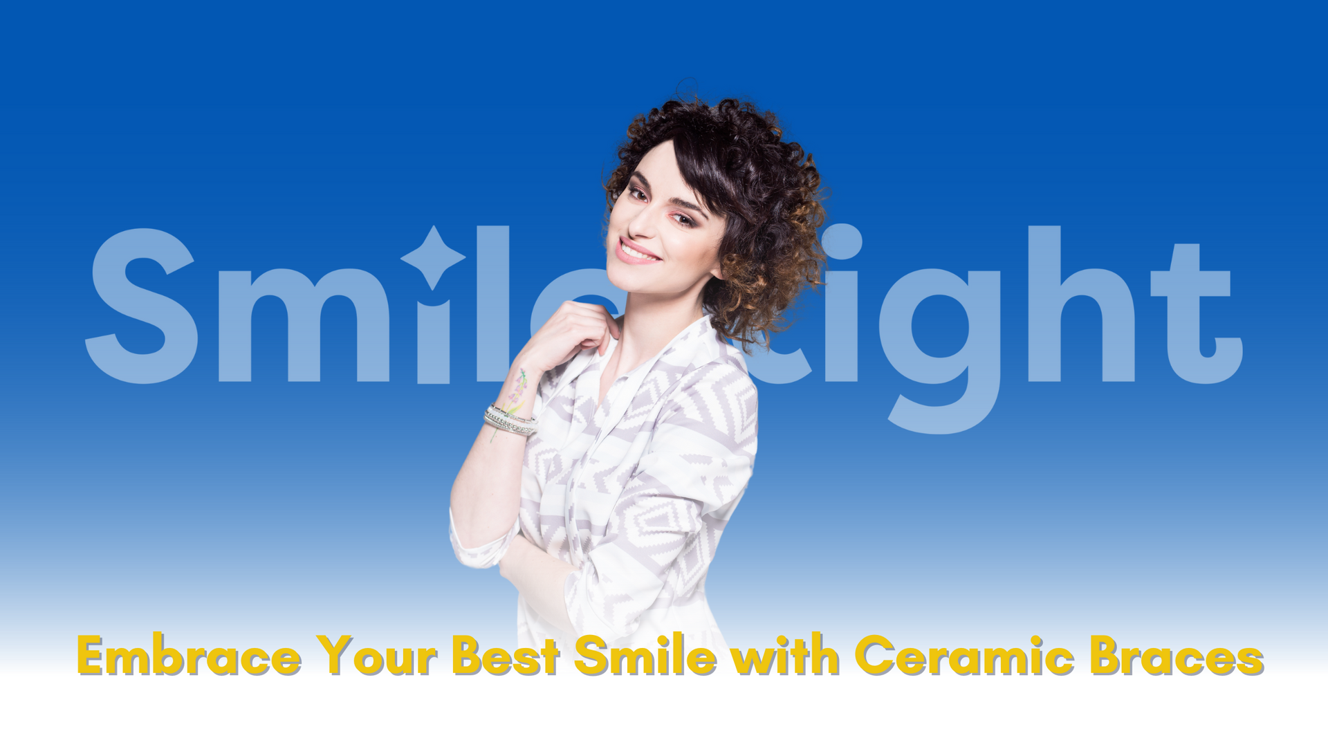 A woman is standing in front of a blue background with the words `` smile light '' written on it.