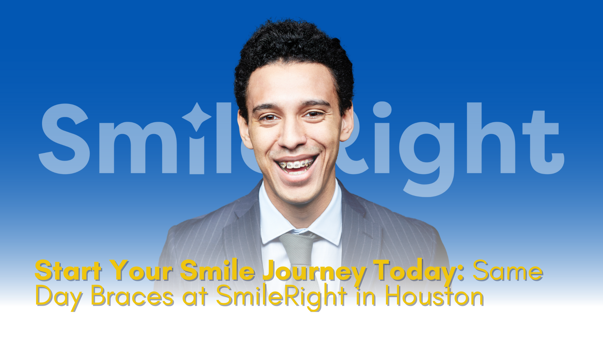 A man in a suit and tie is smiling in front of a blue sky.