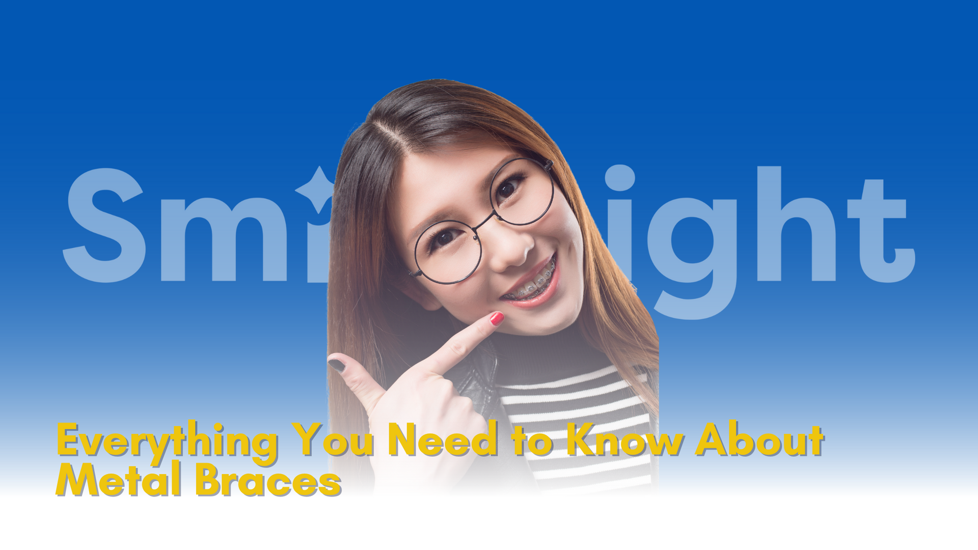 A woman wearing glasses is pointing at her teeth.