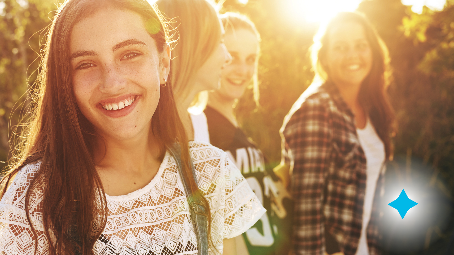 A group of young women are standing next to each other and smiling.