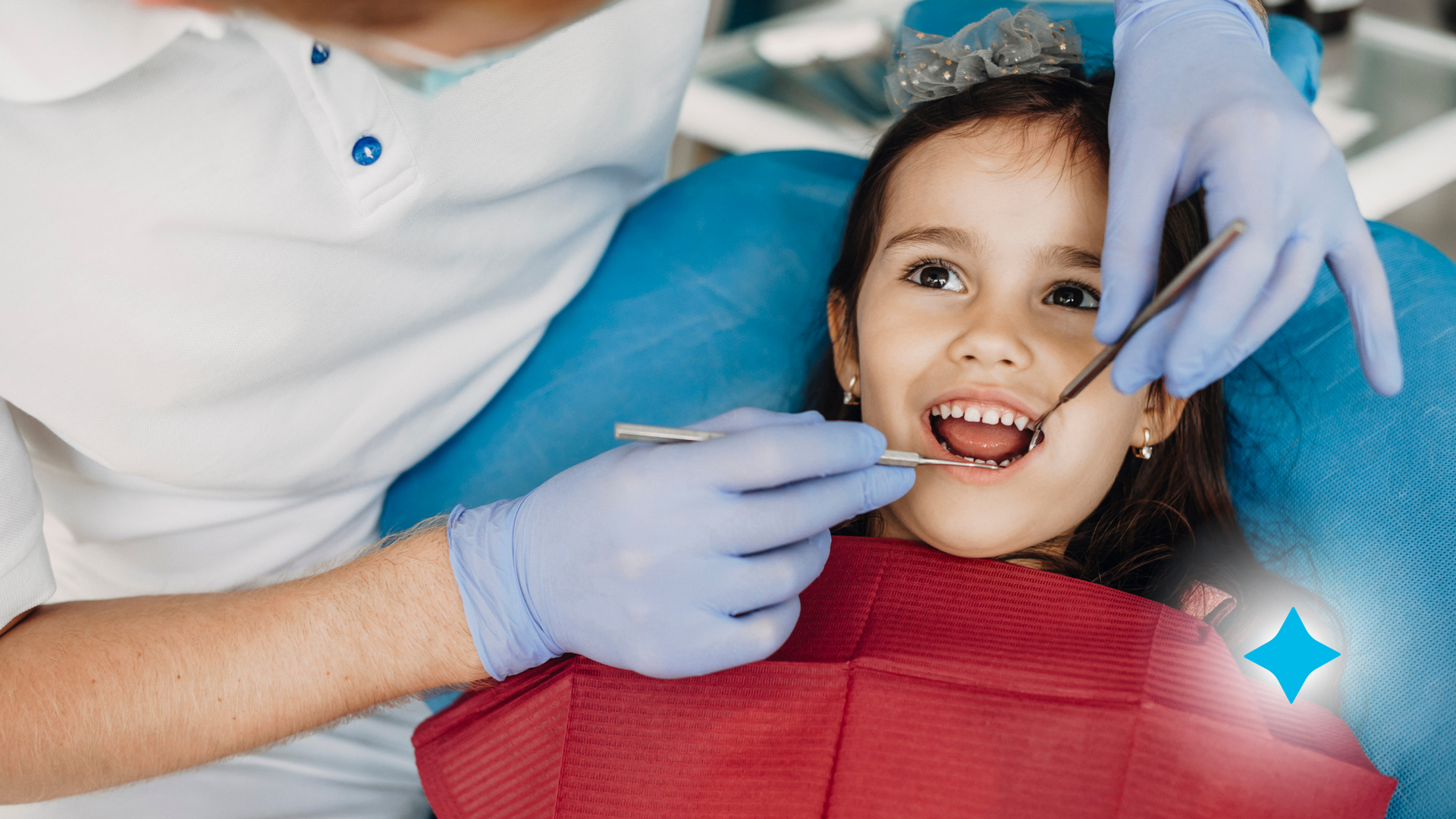 A little girl is sitting in a dental chair getting her teeth examined by an orthodontist.