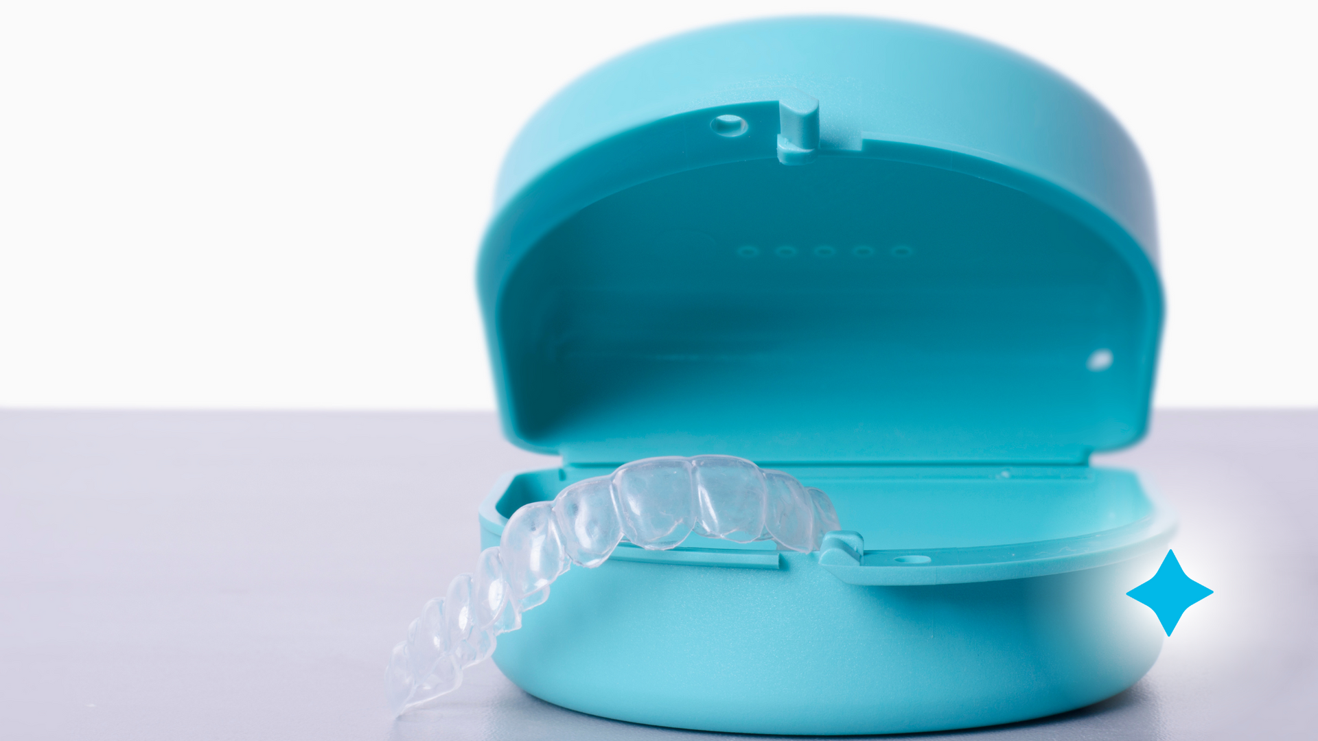 A blue container with a clear retainer inside of it