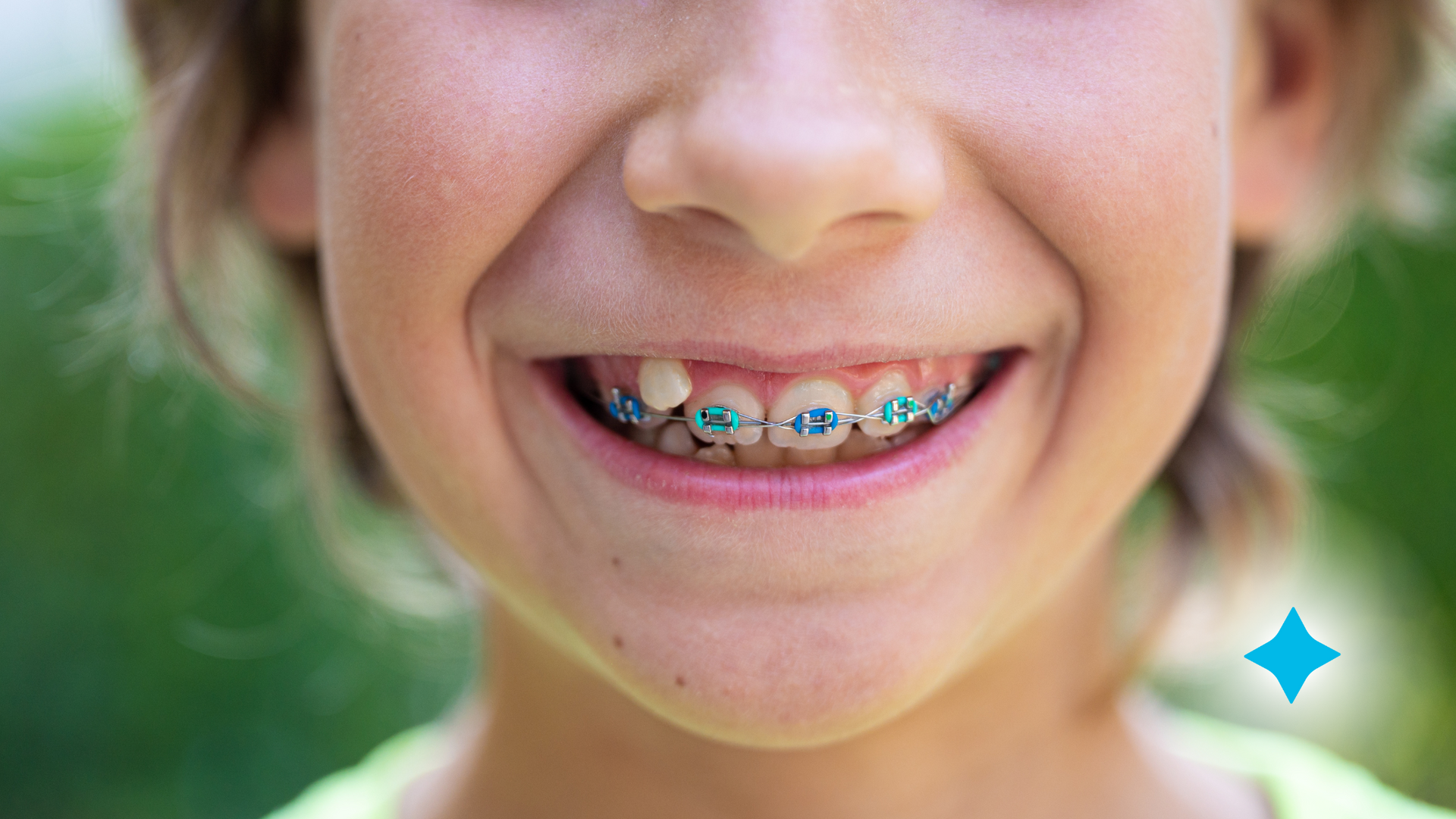 A close up of a young girl with braces on her teeth.