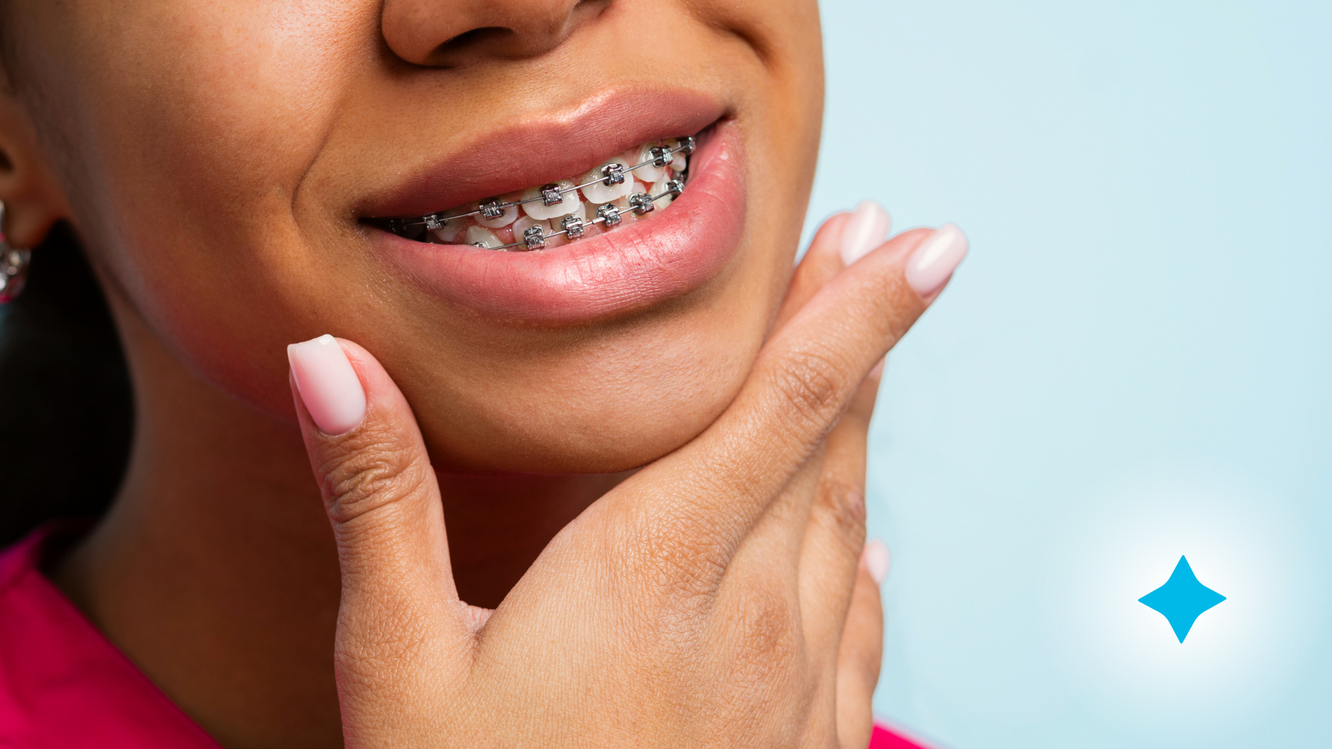 A close up of a woman 's face with braces on her teeth.