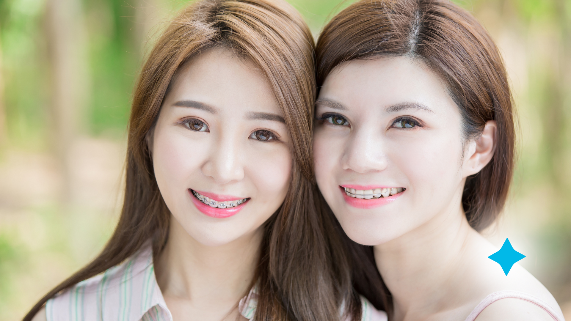Two young women are smiling for the camera while standing next to each other.
