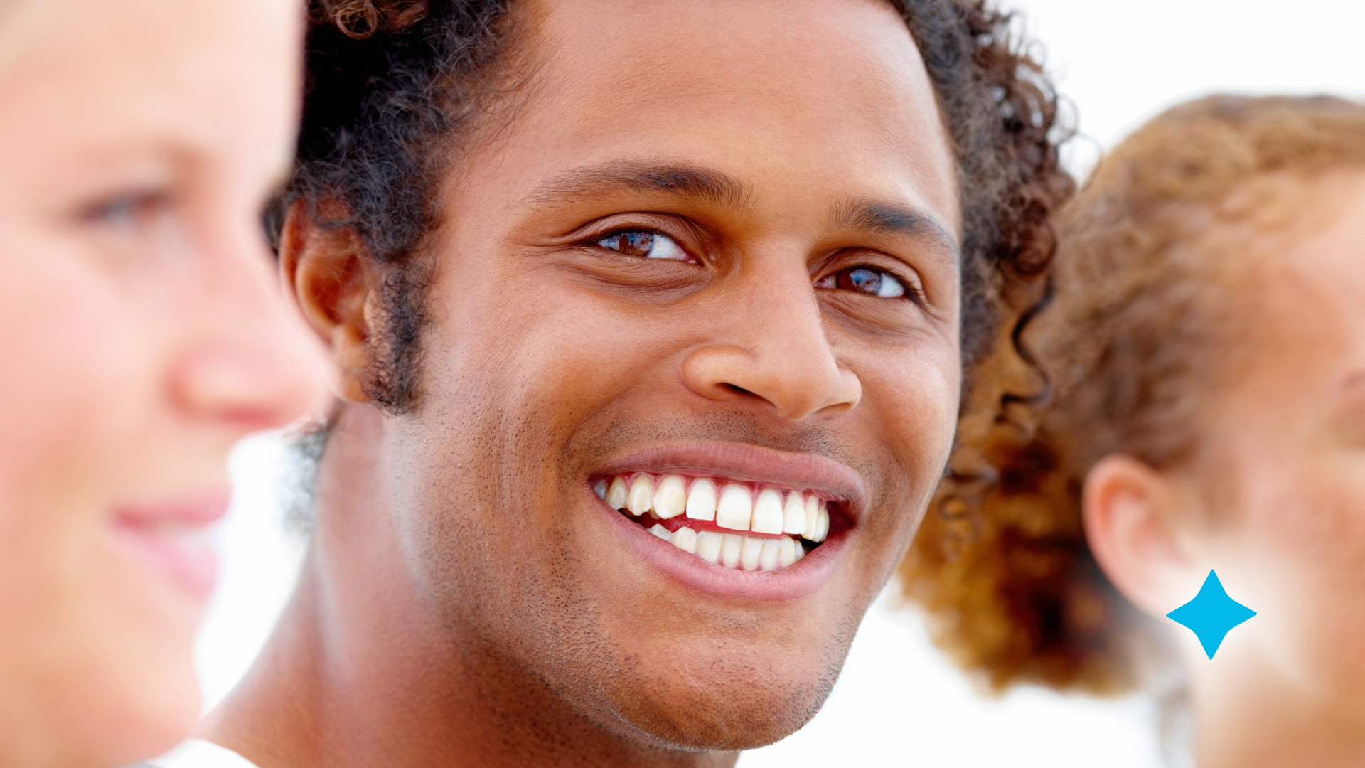 A group of people are standing next to each other and smiling.