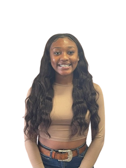 A woman with long hair is wearing a tan crop top and a brown belt.