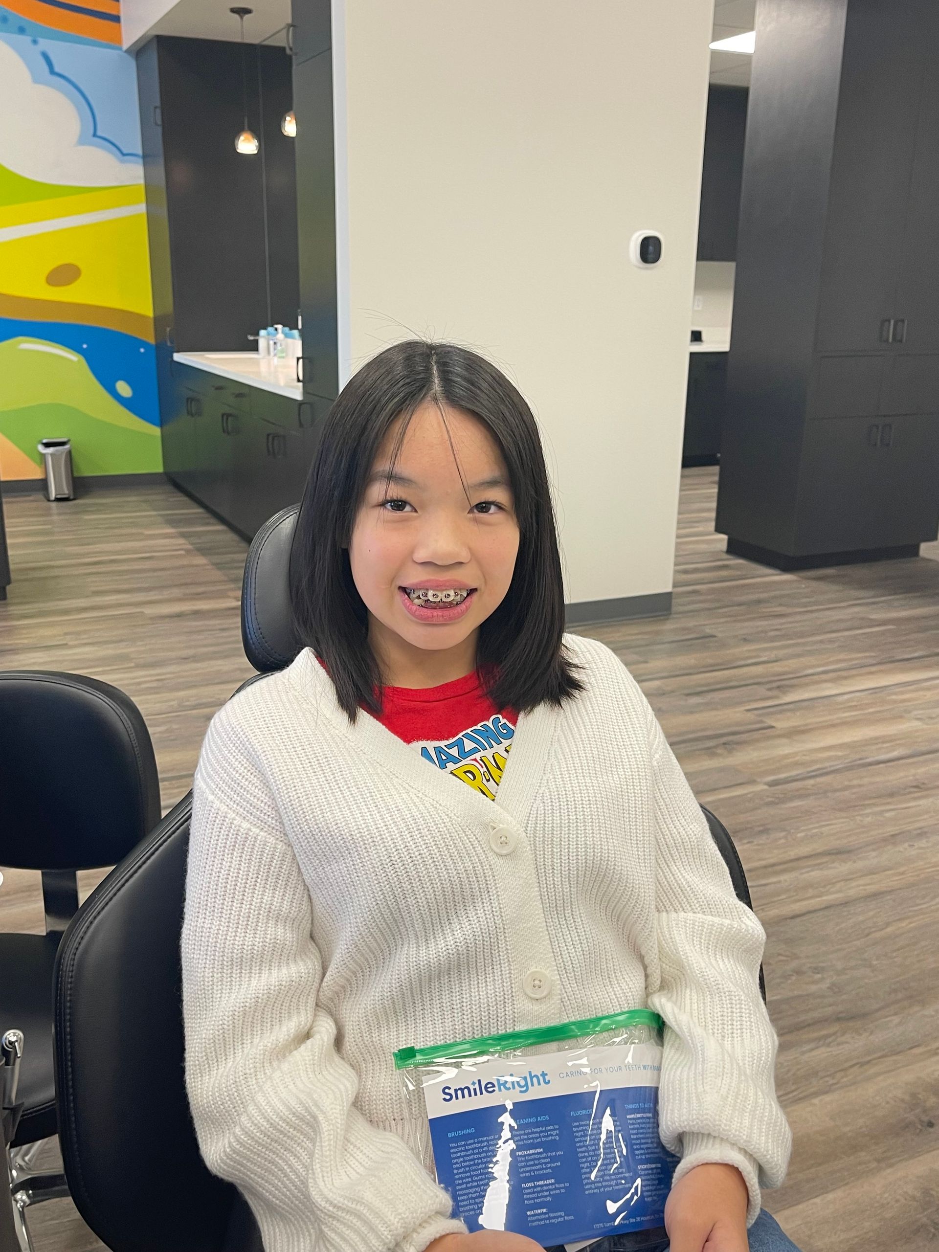girl smiling after getting braces put on