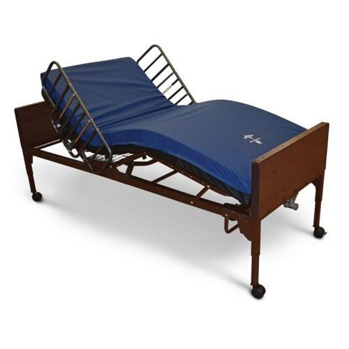 Adjustable hospital bed with blue mattress and raised side rails, brown frame, on wheels