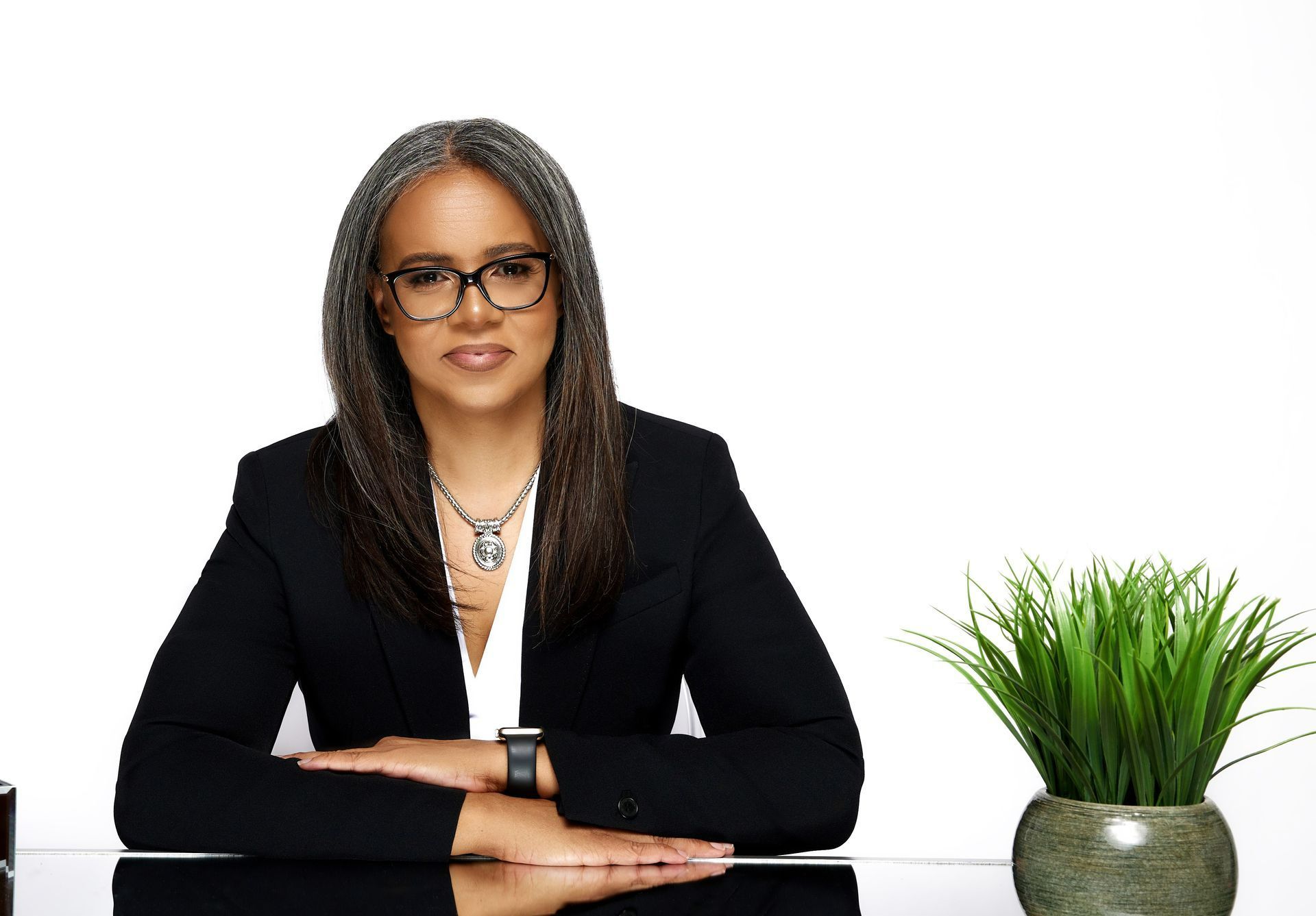 Executive woman wearing glasses sitting at a desk