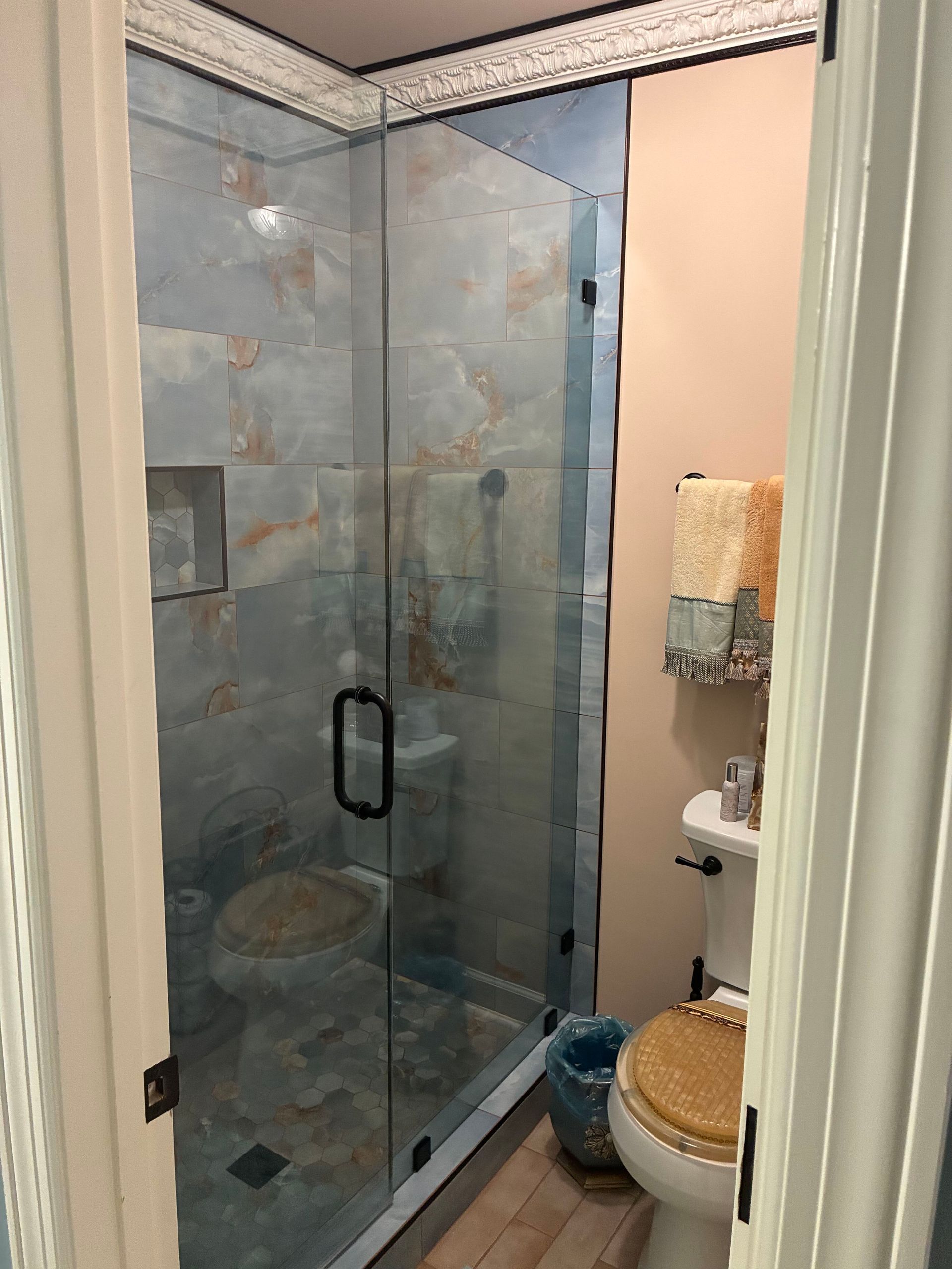 Double vanity bathroom with white cabinets, large mirrors, and gray walls in a bright, modern interior