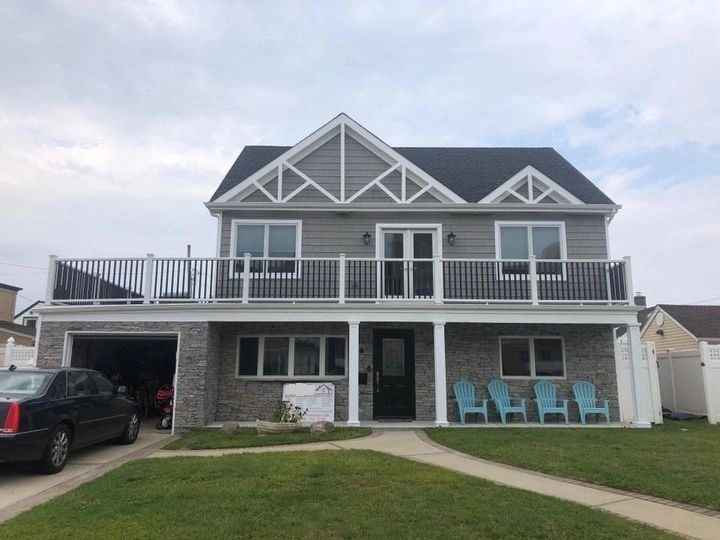 A large house with a car parked in front of it.