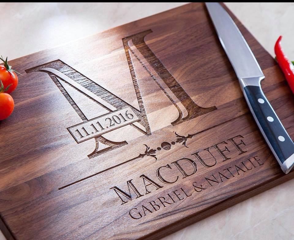 A wooden cutting board with the name macduff written on it