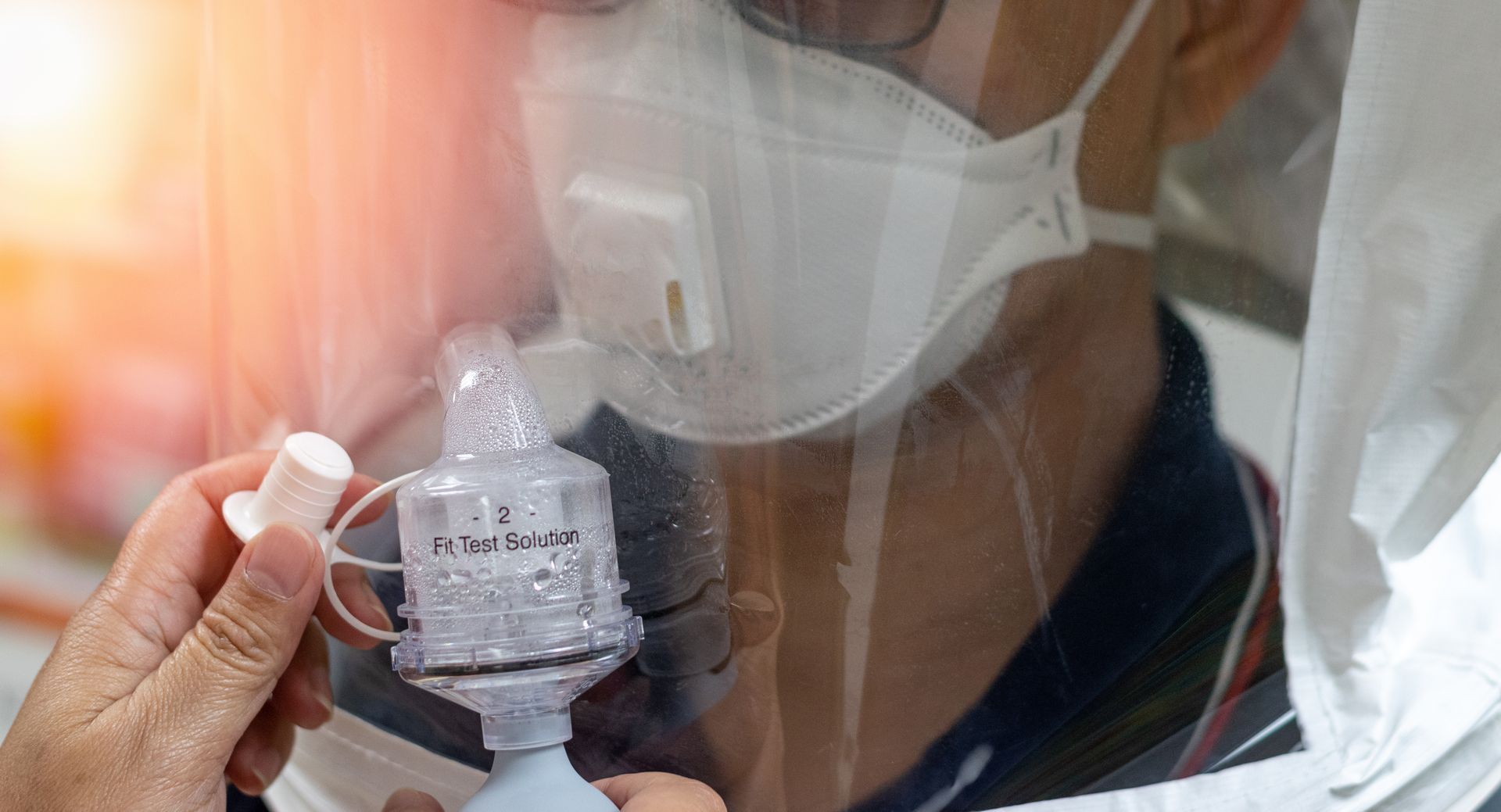 Healthcare worker wearing a mask using a nebulizer on a patient