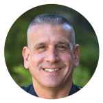 A man is smiling for the camera in a circle.