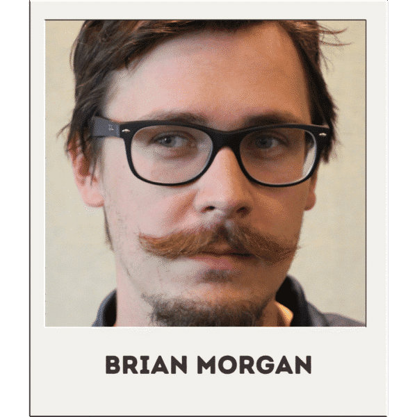 Brian Morgan, man with glasses and large mustache, smiling slightly.