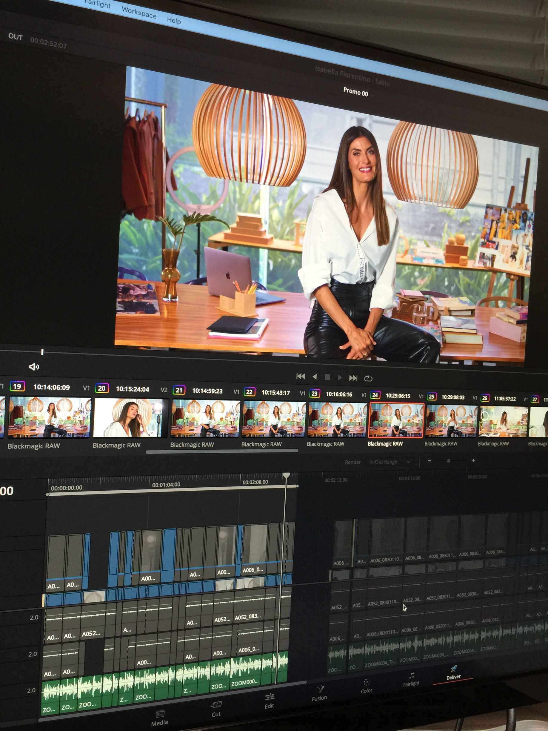 Woman in white shirt and leather pants on screen, video editing interface visible.