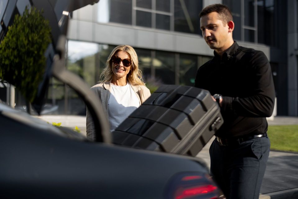 Chauffeur putting luggage in trunk