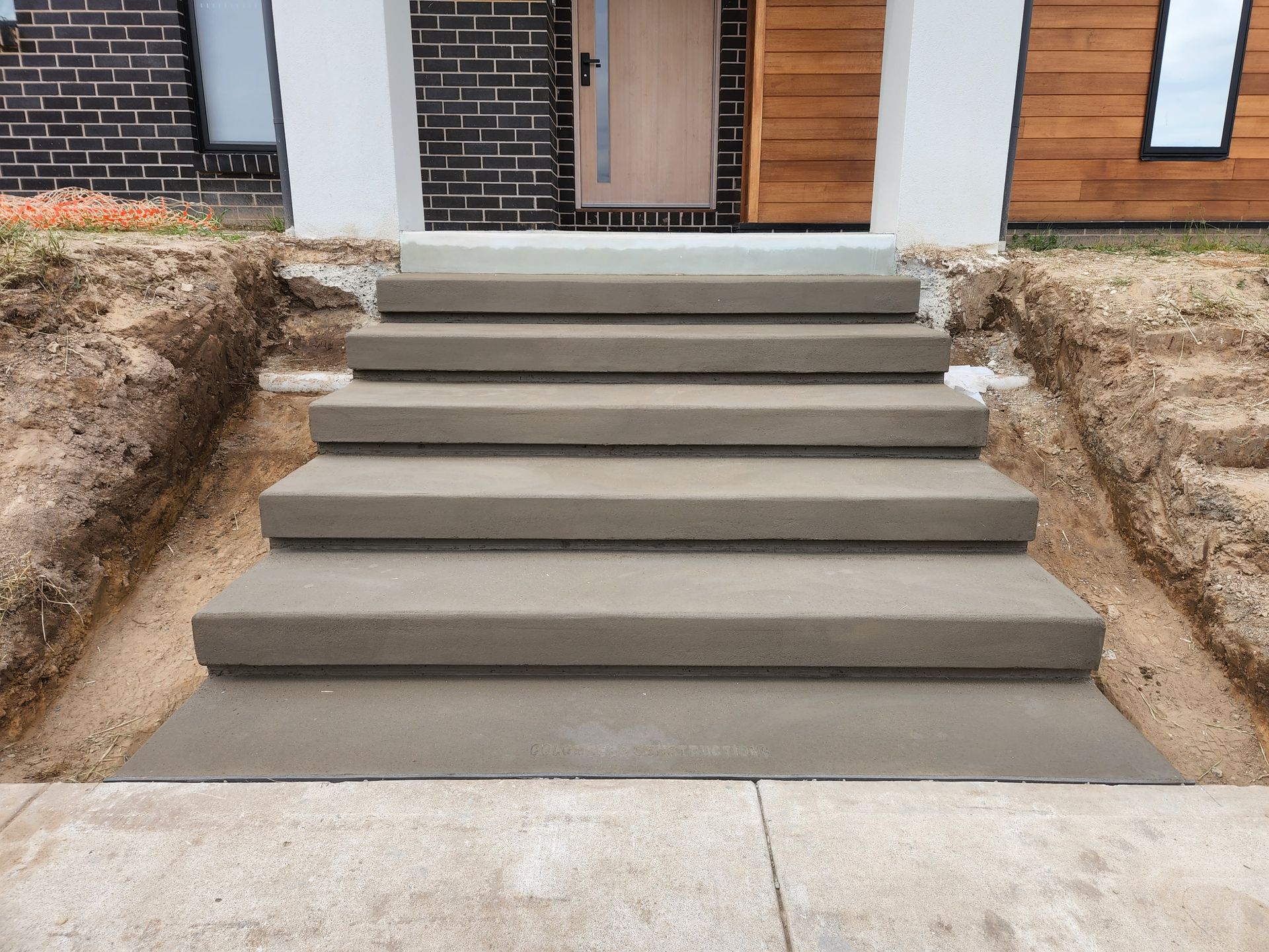 A set of concrete steps leading up to a house
