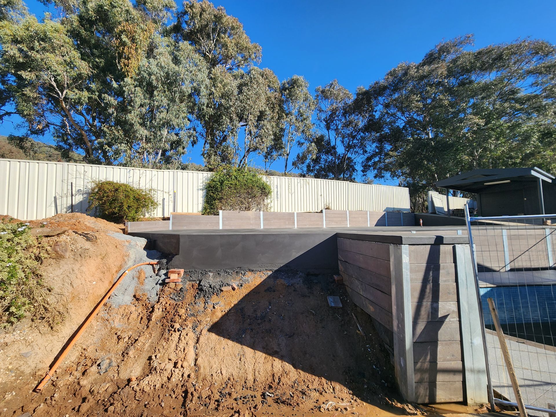 A large pile of dirt is sitting in front of a house.