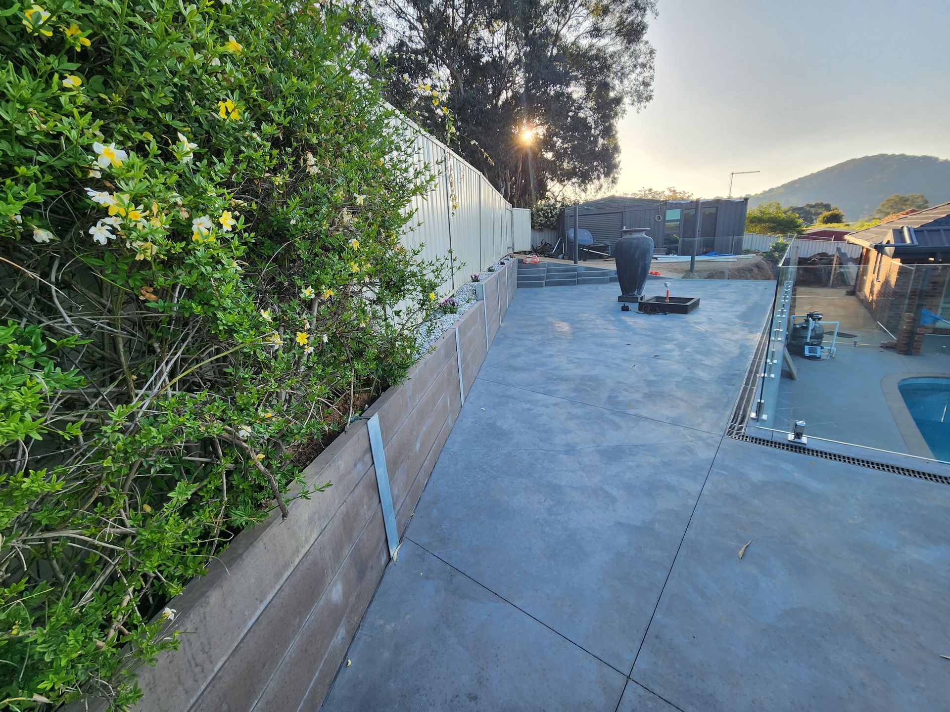 Concrete slab next to a pool with large pot -Colombera Constructions In Wodonga, VIC