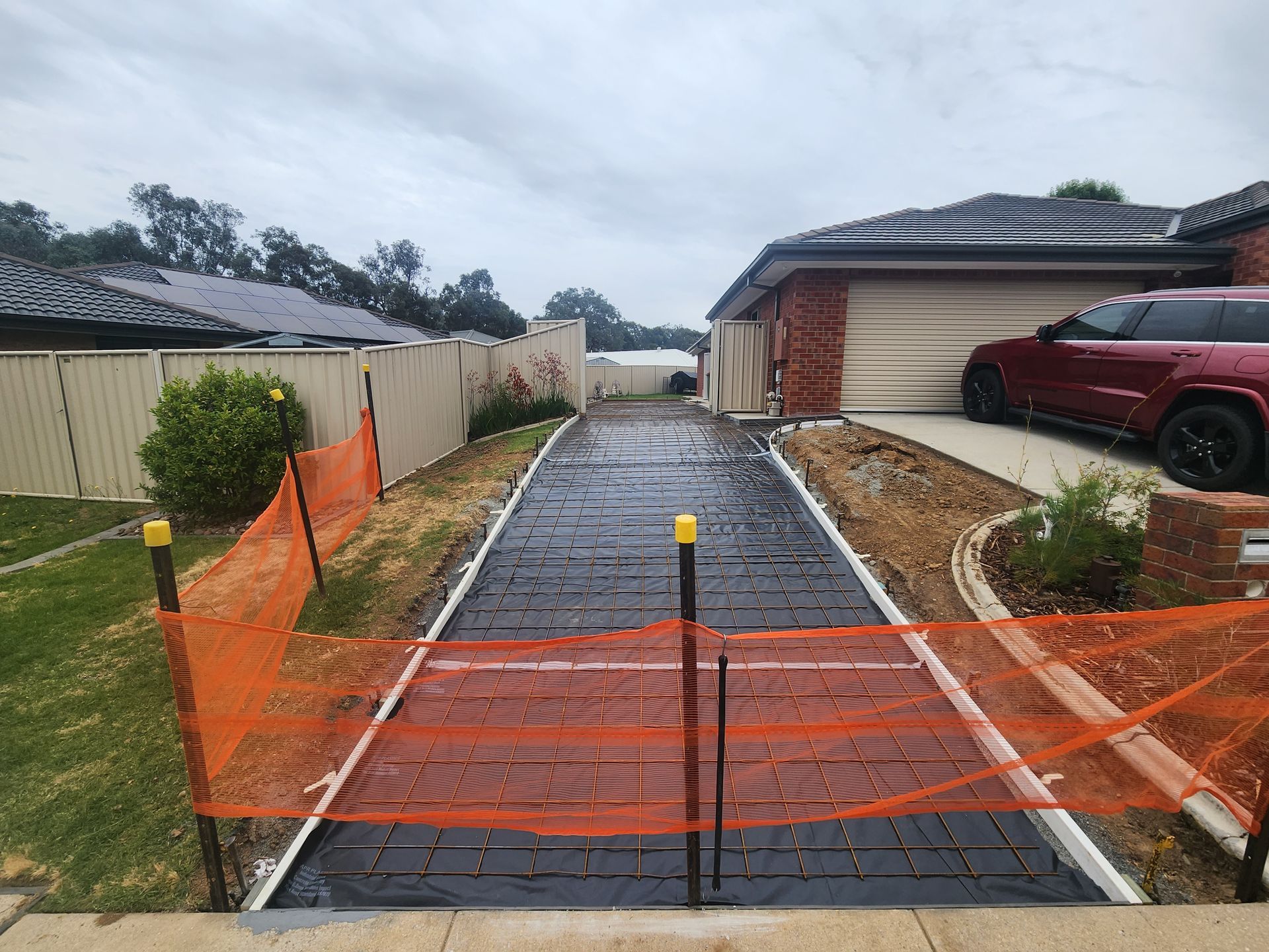 A driveway is being built in front of a house.